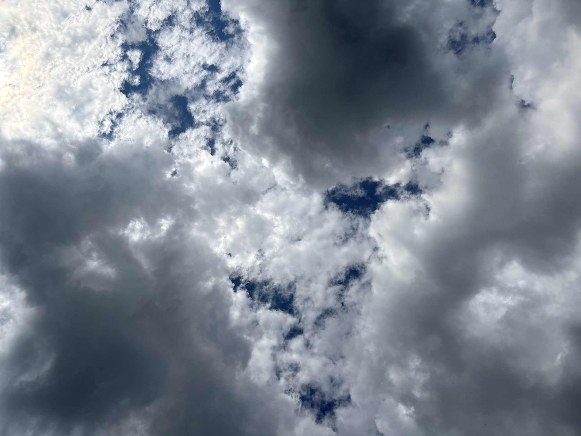 The image shows a cloudy sky with a mix of dark and white clouds. The sky is blue in some areas where the clouds are thinner. There are no people, subjects, objects, or actions depicted in the image. The scene is an outdoor environment, specifically the sky above the city of Oreshak, Bulgaria.