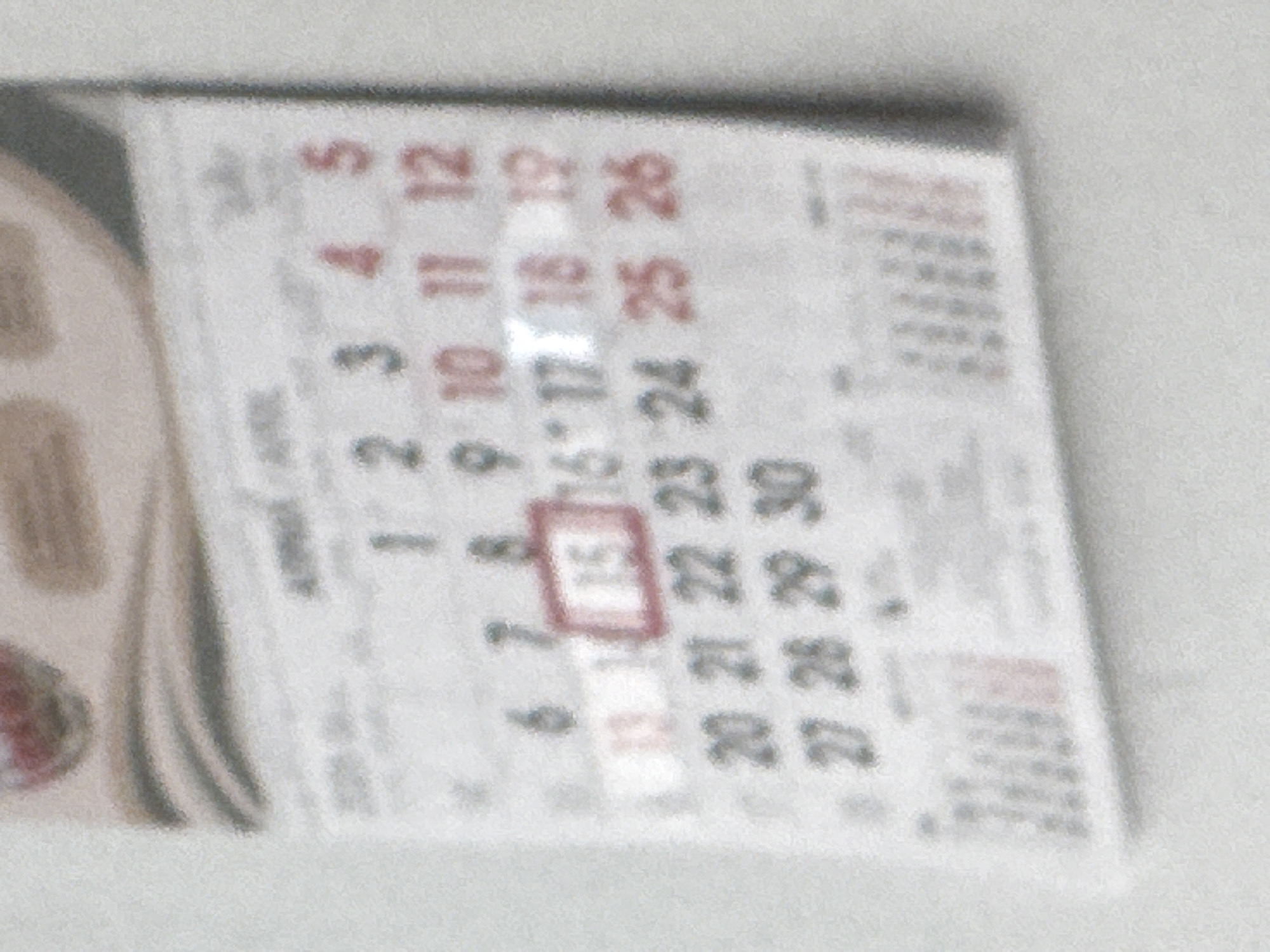 A blurry image shows part of a calendar. The calendar is oriented at an angle, such that the bottom right corner is closer to the viewer. The month is April. The numbers 1-5 are on the first row. The second row is 7-12. The number 15 is in a red box. The last day shown is April 30. The image is generally blurred and out of focus. There is no information available to conclude the location is Varna, Bulgaria.