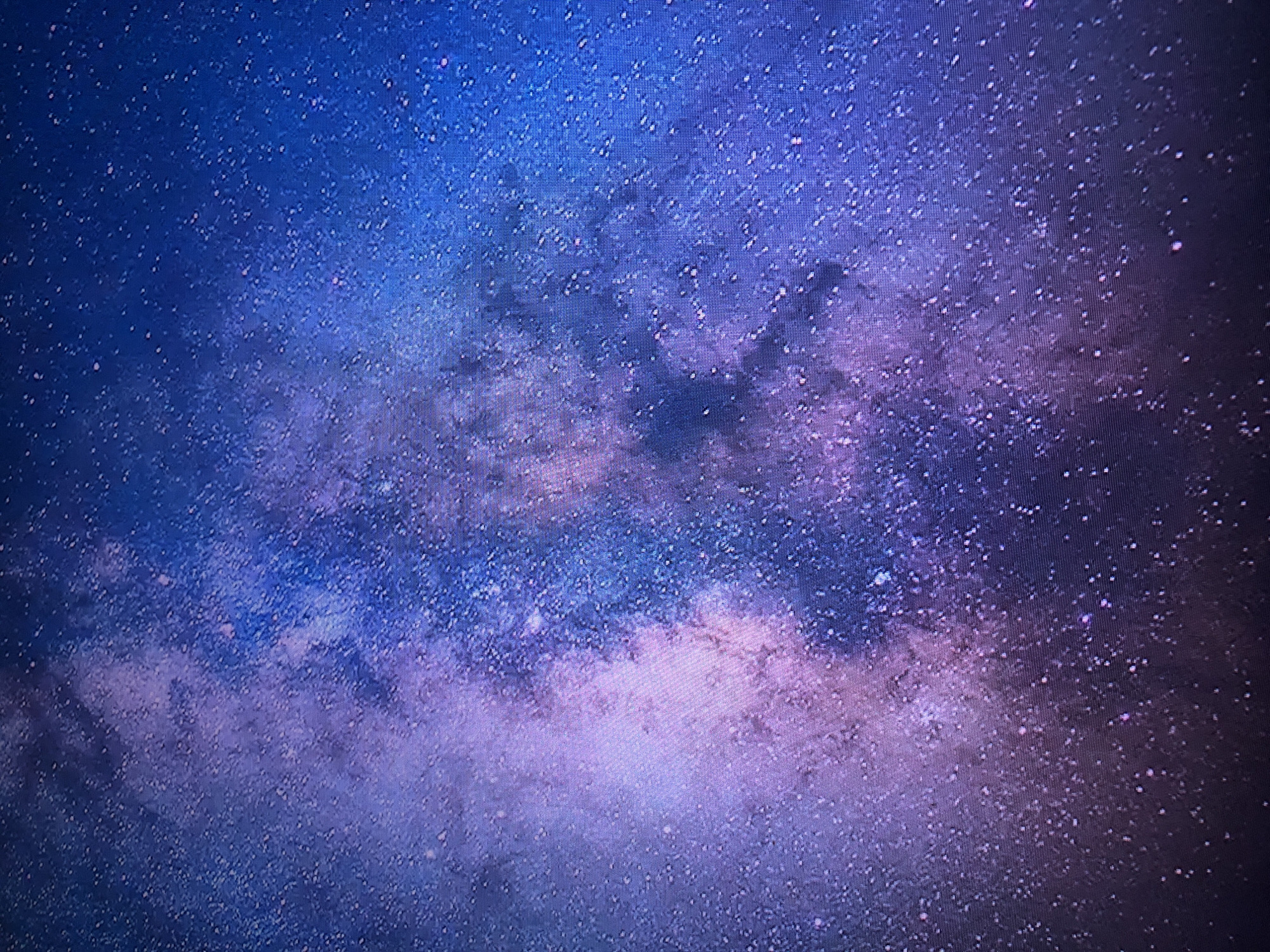 The image shows a cosmic scene, possibly a photograph or digital rendering of a nebula or galaxy. The color palette ranges from deep blues and purples to lighter pinks and whites. Numerous small, bright dots are scattered across the scene, resembling stars. There is no indication of Buenos Aires or any terrestrial location. There are no people, subjects, objects, actions, or interactions visible. The environment depicted is celestial in nature.