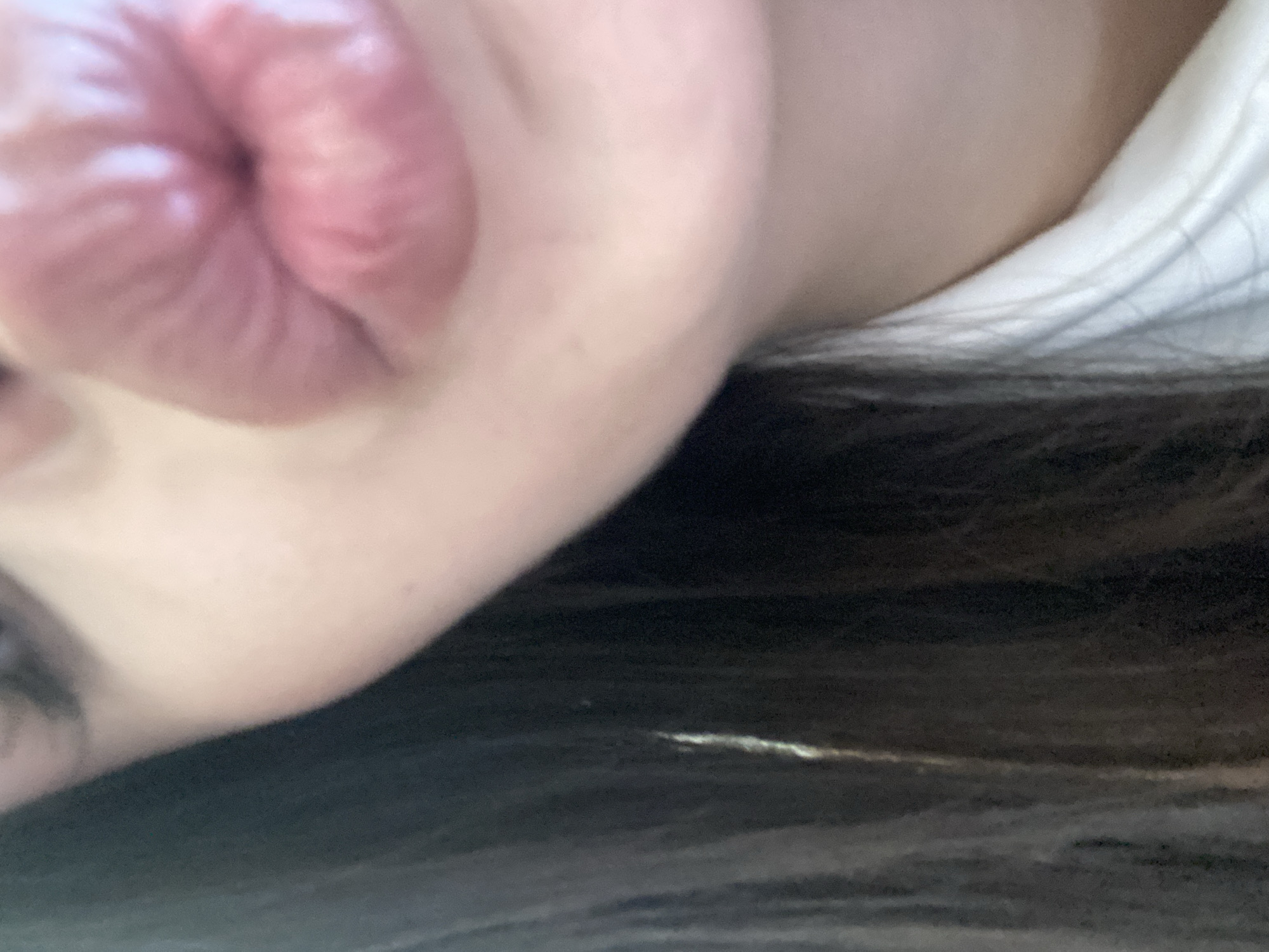 The image shows a close-up of a person's face, specifically the lips pursed into a kiss, cheek, eyelashes, and some dark hair. Part of a white garment is visible in the background. There is no information in the image indicating that the location is Sofia, Bulgaria.