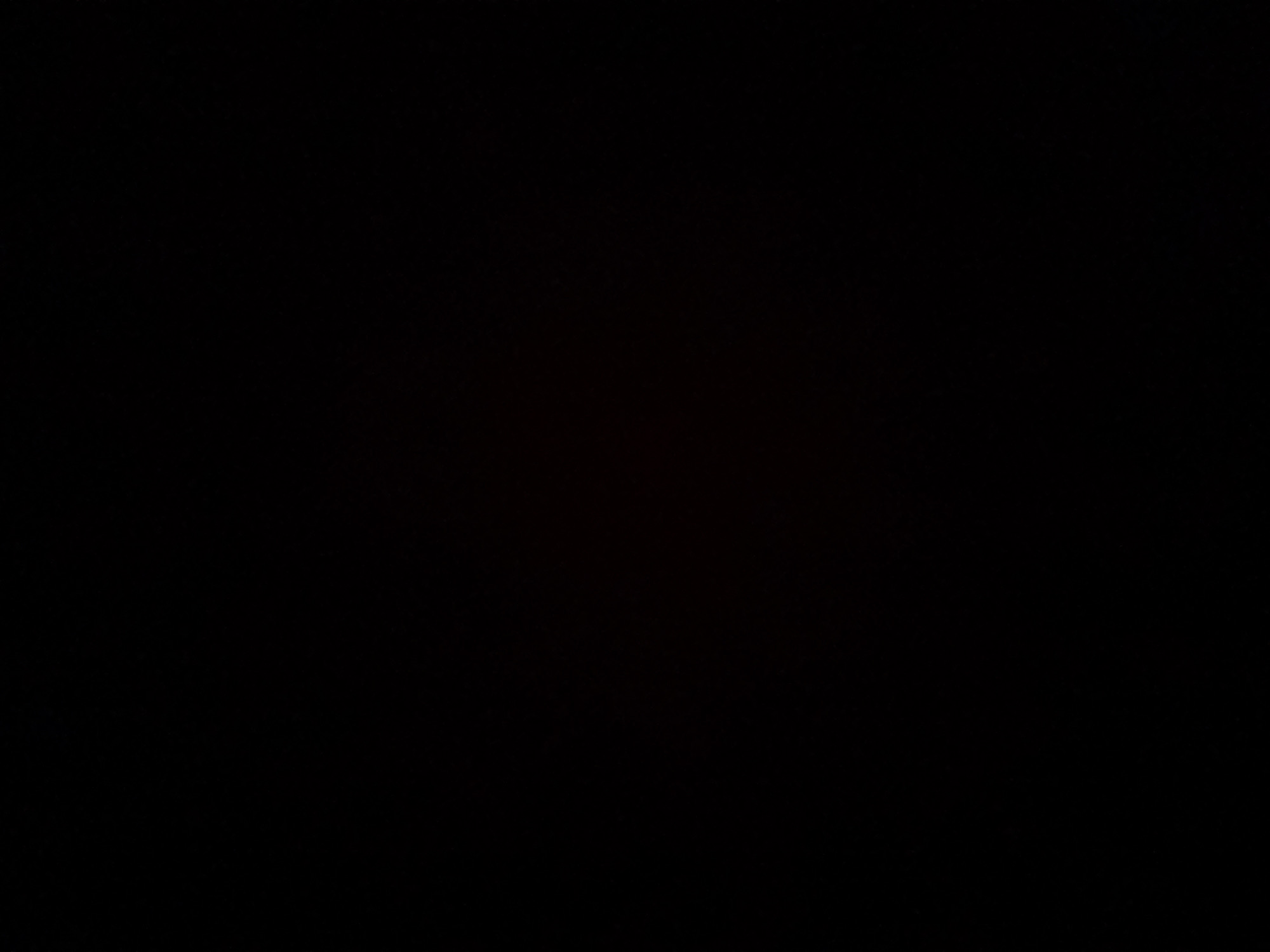 The image is entirely black and contains no visible content. Therefore, it is not possible to provide a description of a scene, people, subjects, objects, actions, interactions, or the environment, nor to specify a location in a city.