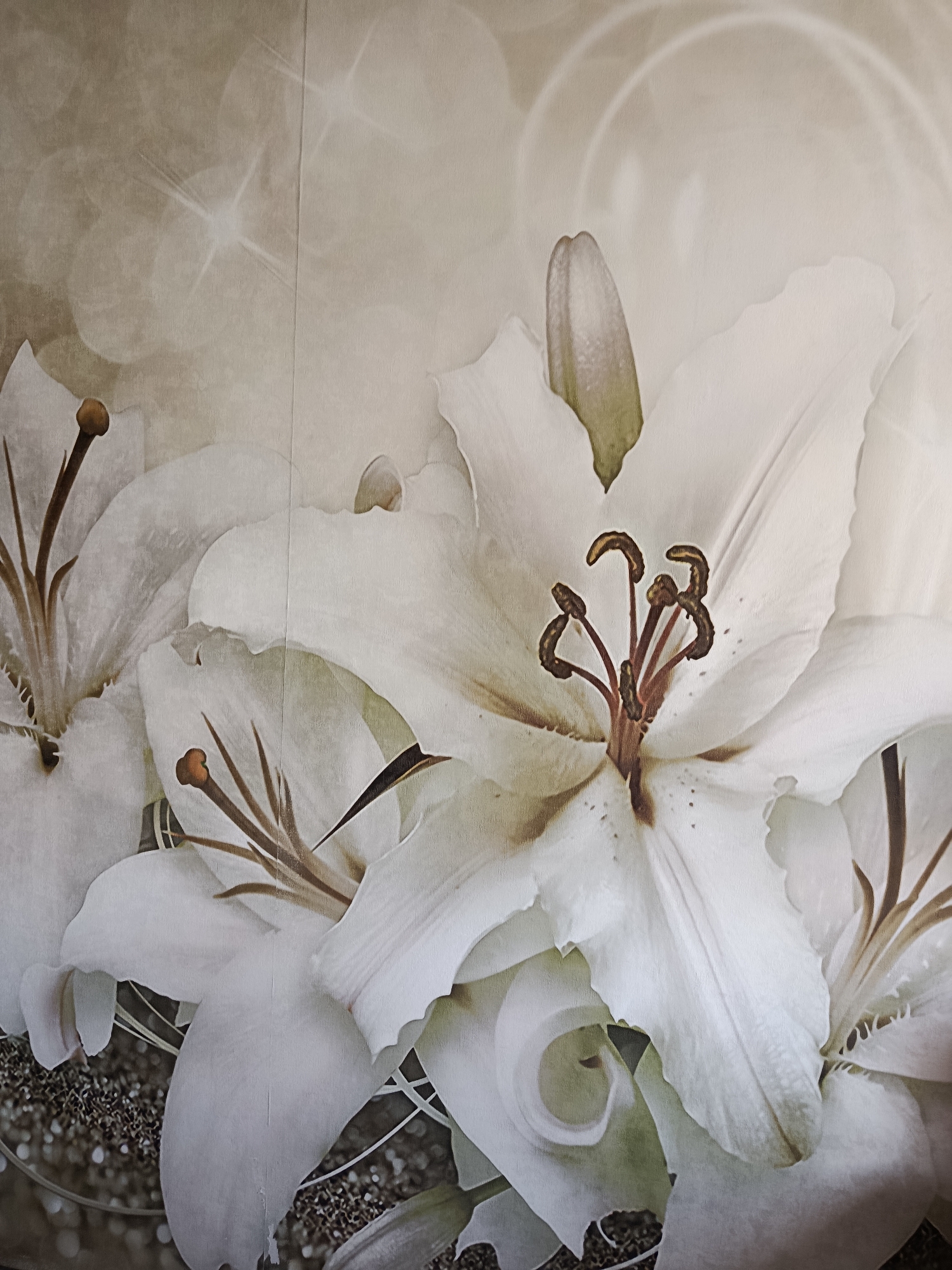 The image displays a close-up view of several white lilies, rendered in a painterly style. The flowers are predominantly white with subtle hints of beige and green in their petals and stamens. The background is a soft, neutral tone with bokeh effects and subtle sparkling highlights, suggesting a soft focus or a shimmering atmosphere. The lilies are arranged in a clustered fashion, with some petals overlapping and others reaching outwards. The stamens and pistils are visible in the center of the flowers, featuring brown and reddish hues. The bottom portion of the image shows a dark, textured area with sparkling particles, possibly representing a base or ground with glitter. The overall impression is one of elegance and softness, with a focus on the delicate details of the floral subjects. There are no people, animals, or specific urban landmarks visible in this image, and therefore, no specific location in the city of Svietlahorsk, Belarus can be identified from this photograph alone.