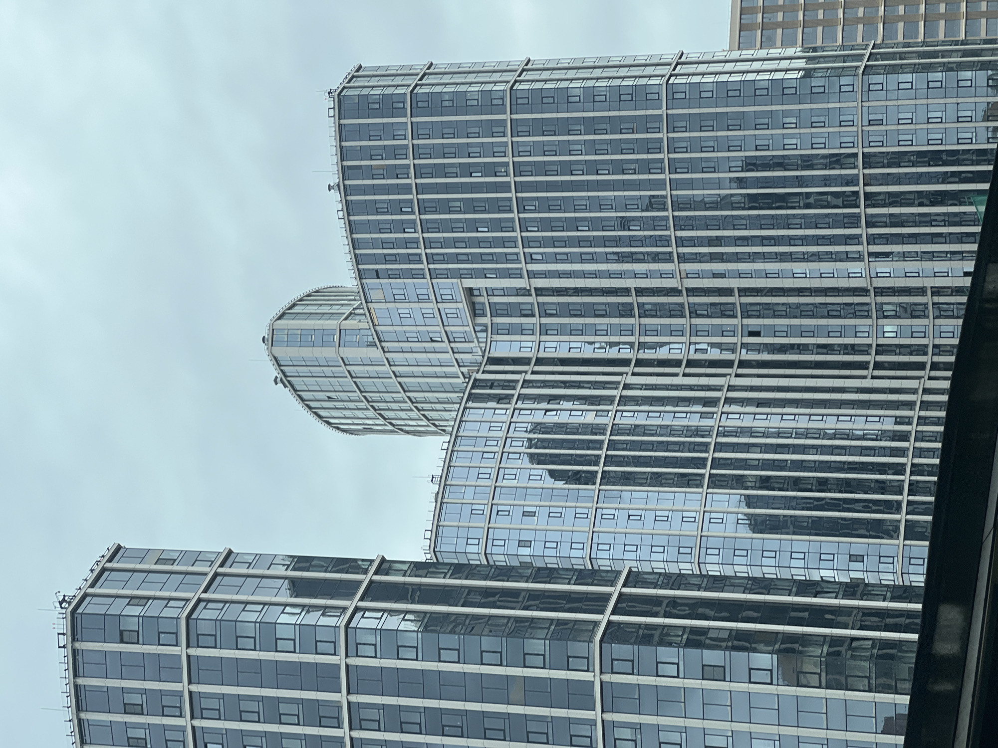 The image shows a view of the residential complex "Art Residence" in Khimki, Russia. The buildings are modern glass skyscrapers with curved facades. The sky is overcast.