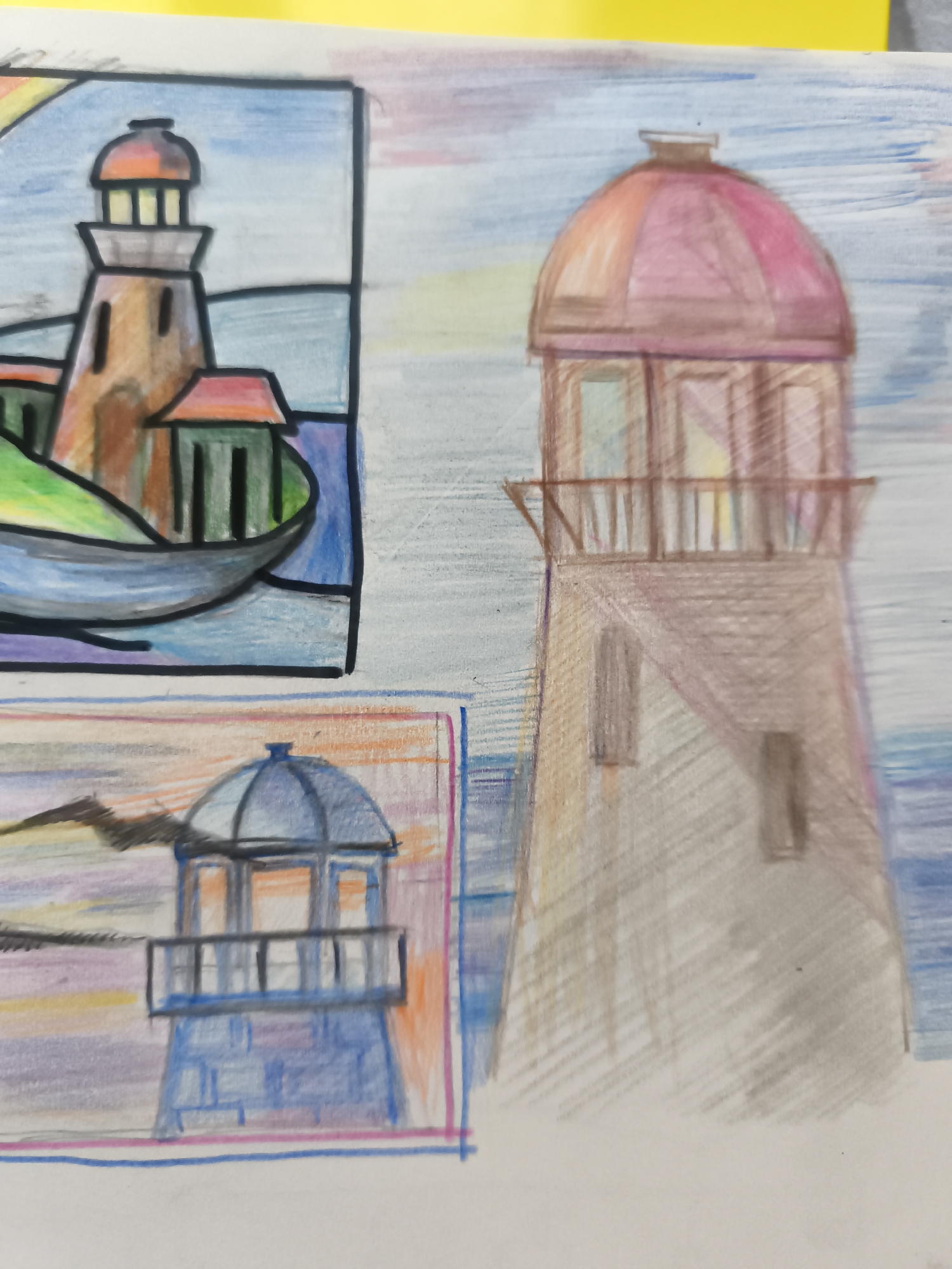 The image is a close-up, slightly angled shot of a drawing, possibly done with colored pencils. The drawing features multiple lighthouses. In the upper left quadrant, a lighthouse with an orange and brown top, and a brown body with green structures beside it, is depicted within a bordered frame. The scene includes water and a hint of a rainbow. To the right of this, a larger, more detailed lighthouse with a pinkish-brown dome and a brown body is drawn, set against a sky with horizontal blue and white lines. In the lower section of the image, another lighthouse with a blue, domed top and a blue brick-like base is visible, again within a bordered frame, with a muted landscape and sky in the background. The overall impression is of an artistic study of lighthouses. The location in the city of Saint-Denis, France, is not depicted or suggested by any visual elements in the drawing.