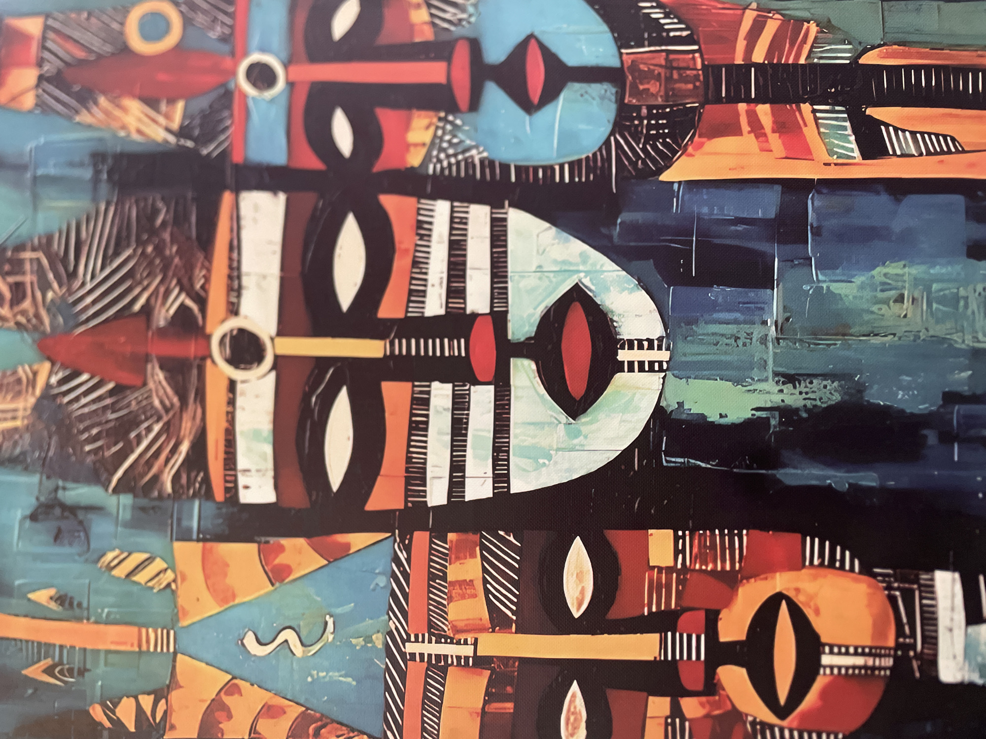 The image is a painting of three stylized masks with intricate patterns and vibrant colors. The masks are arranged in a vertical composition, with the central mask being the largest and most prominent. Each mask has distinct features, including large, almond-shaped eyes, prominent noses, and red lips. The masks are adorned with geometric patterns, lines, and shapes in shades of orange, blue, black, white, and red. The background is a textured blend of blues and greens, with some abstract elements. The painting has a somewhat rough, textured appearance, suggesting it is a physical artwork. The style is abstract and tribal, reminiscent of African masks.