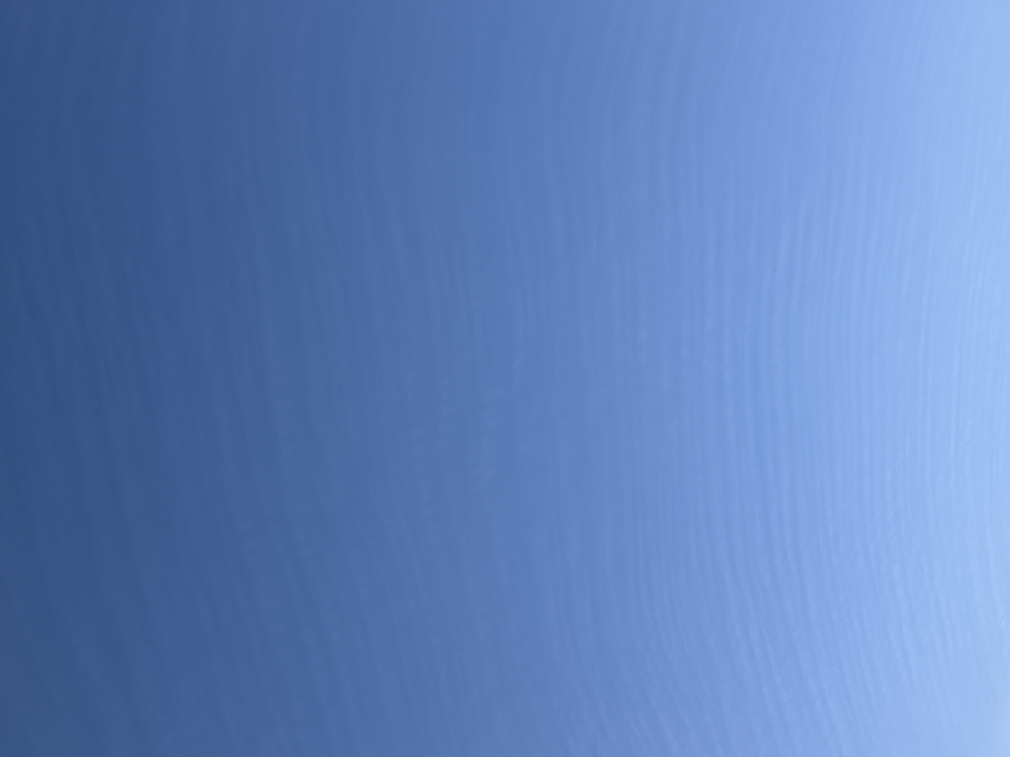 The image depicts a clear, blue sky. It's not possible to determine the location in Dmitrov, Russia, from just the image of the sky. There are no visible subjects, objects, or actions in the scene. The environment is simply a blue sky.