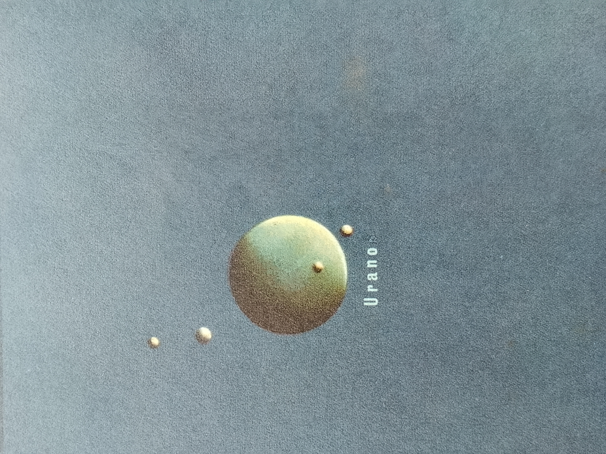 The image depicts a stylized illustration of the planet Uranus and several of its moons against a dark blue background. The name "Uranus" is printed vertically in white letters to the right of the planet. There is no indication of the location being Altagracia, Venezuela, or any people, subjects, objects, actions, interactions, or environment related to that city.