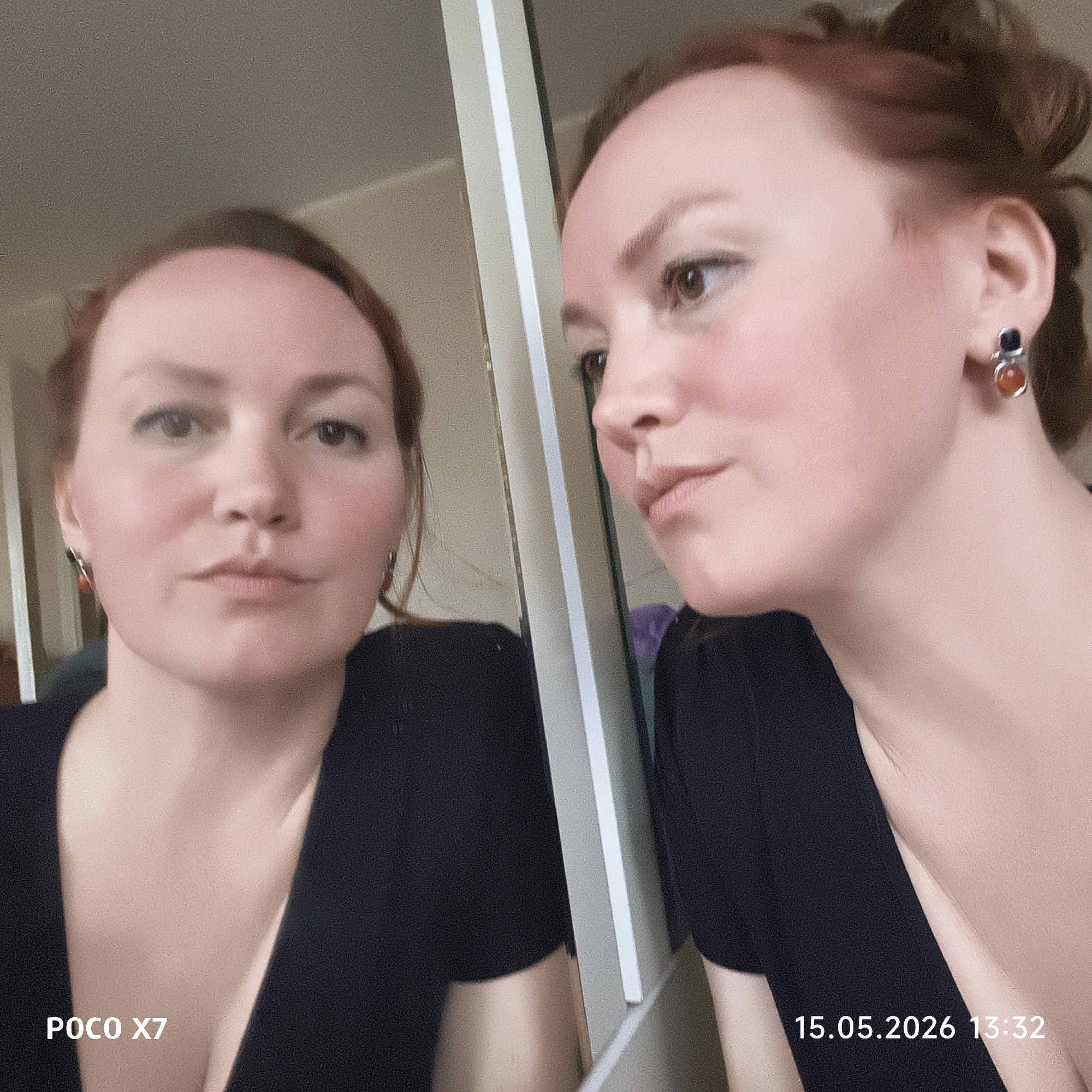 A woman with reddish hair is standing in front of a mirror. She wears a black V-neck top and earrings with black and orange stones. Her hair is loosely pulled back. The reflection in the mirror shows her face head-on, while she is looking to the side at her own profile. The date and time "15.05.2026 13:32" are stamped in the lower right corner of the image, and "POCO X7" is stamped in the lower left. The location is Chaikovsky, Russia.