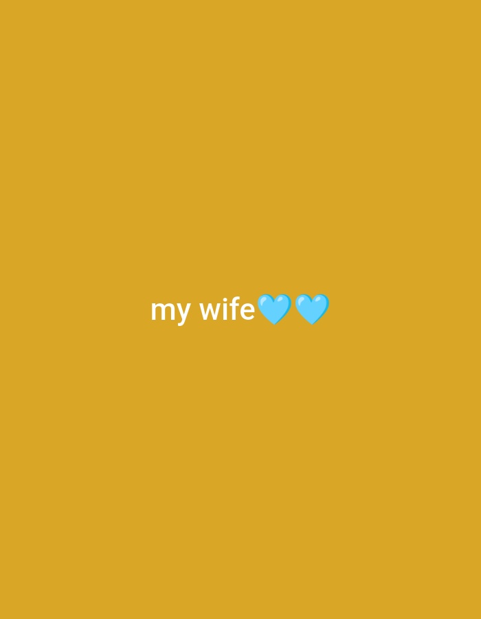 The image is a digital graphic with a mustard-yellow background. In the center of the image, the text "my wife" is displayed in white font. To the right of the text, there are two light blue heart emojis. The image does not depict any specific location in the city of Unknown, Indonesia, nor does it contain any people, actions, or interactions.