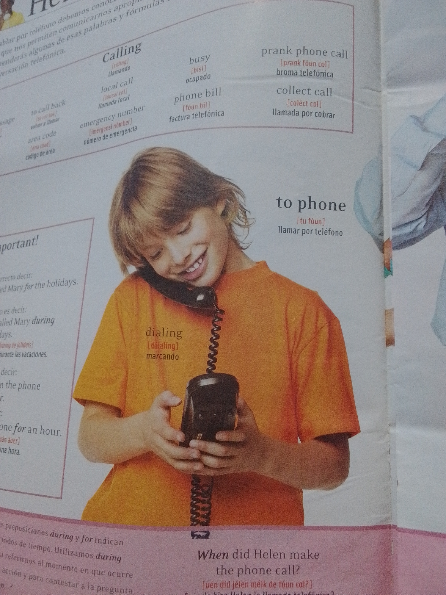 The image shows a page from a Spanish-English language learning book. The page features a vocabulary section with terms related to phone calls. There is an image of a young boy smiling while holding a vintage rotary-style telephone to his ear. The boy is wearing an orange t-shirt. The text on the page is in both English and Spanish, with phonetic pronunciations provided for some terms. The vocabulary includes terms like "Calling," "busy," "local call," "phone bill," "prank phone call," "collect call," "dialing," and "to phone." There is no information or imagery in the provided image that relates to La Tagua, Venezuela.