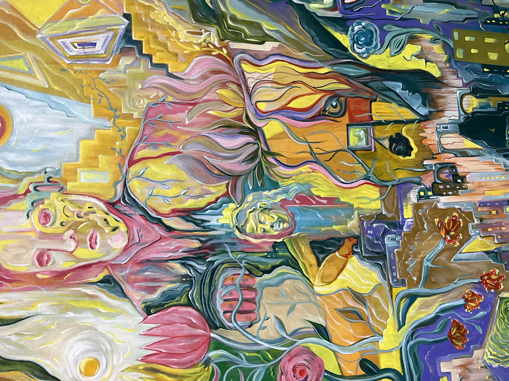 The image is an abstract painting featuring a blend of figurative and architectural elements in a surreal composition. On the left side, a stylized face, possibly female, lies near a staircase-like structure with geometric shapes and a bright yellow sun-like form. The center of the image depicts an expressive, flowing representation of a face or animal head with hair-like waves, intertwined with leafy vines and stems. A smaller, contemplative face is depicted in the lower center. The right side of the image transitions into an urban landscape, with stylized buildings, geometric shapes, and flowers. The color palette consists of bright and varied hues, including yellow, pink, blue, purple, and green. The location is not discernible.