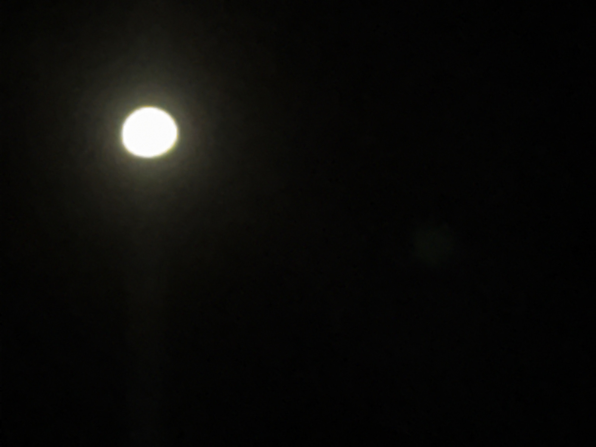 A lone light source illuminates the otherwise dark scene. It is located in the upper left quadrant. A vague, indistinct, dark area exists to the right of the light source.
Based on the scene, there is no way to determine its location in Sofia, Bulgaria, or to say anything about people, subjects, objects, actions, and interactions.