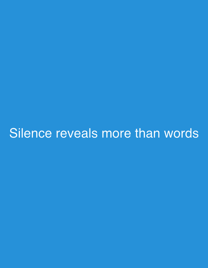 The image displays a solid, vibrant blue background. Centered horizontally and positioned in the lower middle section of the image, white text is prominently displayed. The text reads: "Silence reveals more than words". There are no other subjects, objects, or activities depicted. The setting is abstract, devoid of any specific location cues, people, or discernible time of day. The color contrast between the white text and the blue background makes the message clear and easy to read.