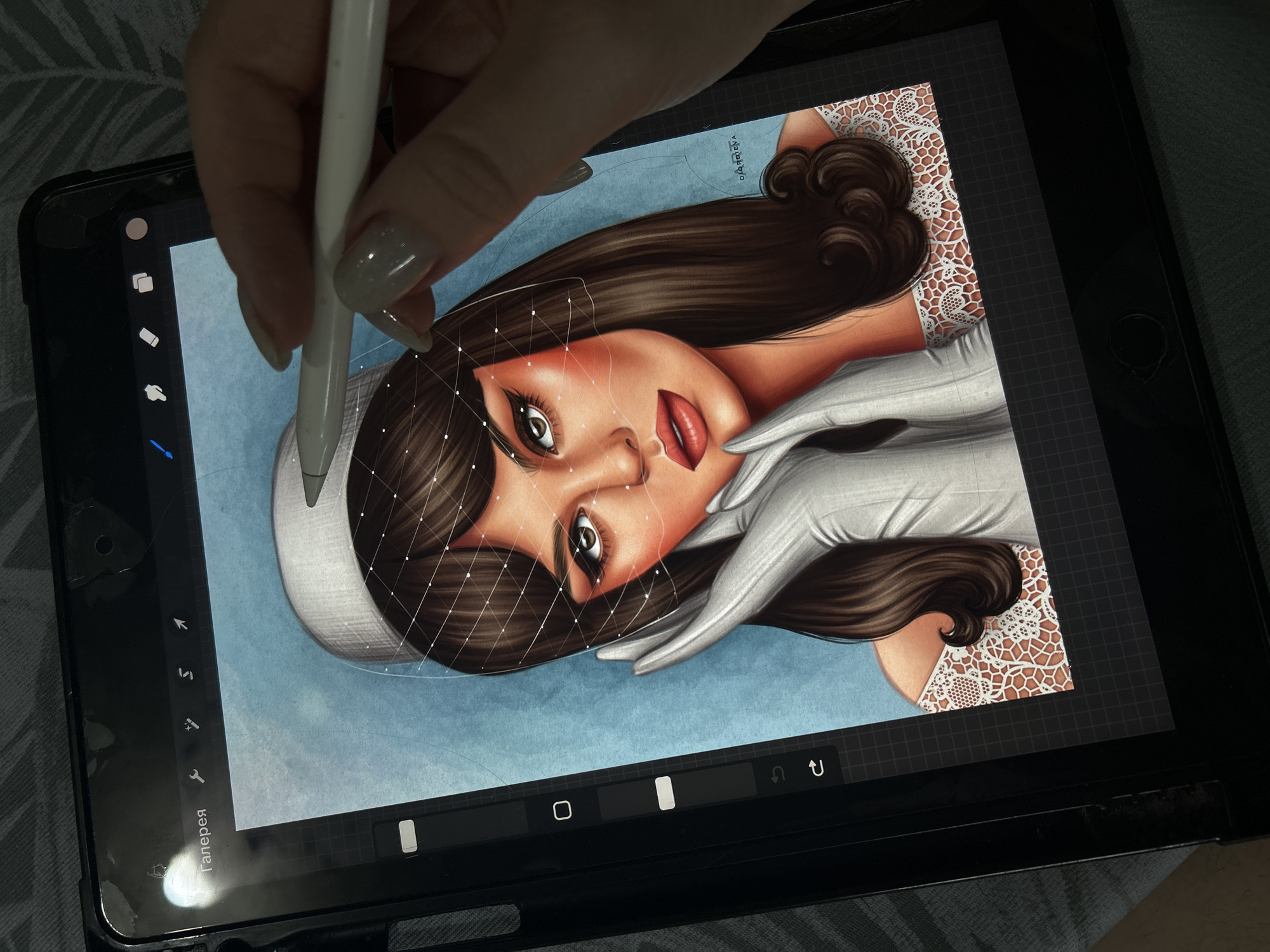 A person is using a stylus to draw a digital image of a woman on a tablet. The drawing shows a woman with brown hair and red lipstick wearing a hat and gloves. The background is blue. The tablet is in a black case and lying on a patterned surface. The person's hand is holding the stylus, which is white. There is no indication of the location of Фоки, Russia in this image.