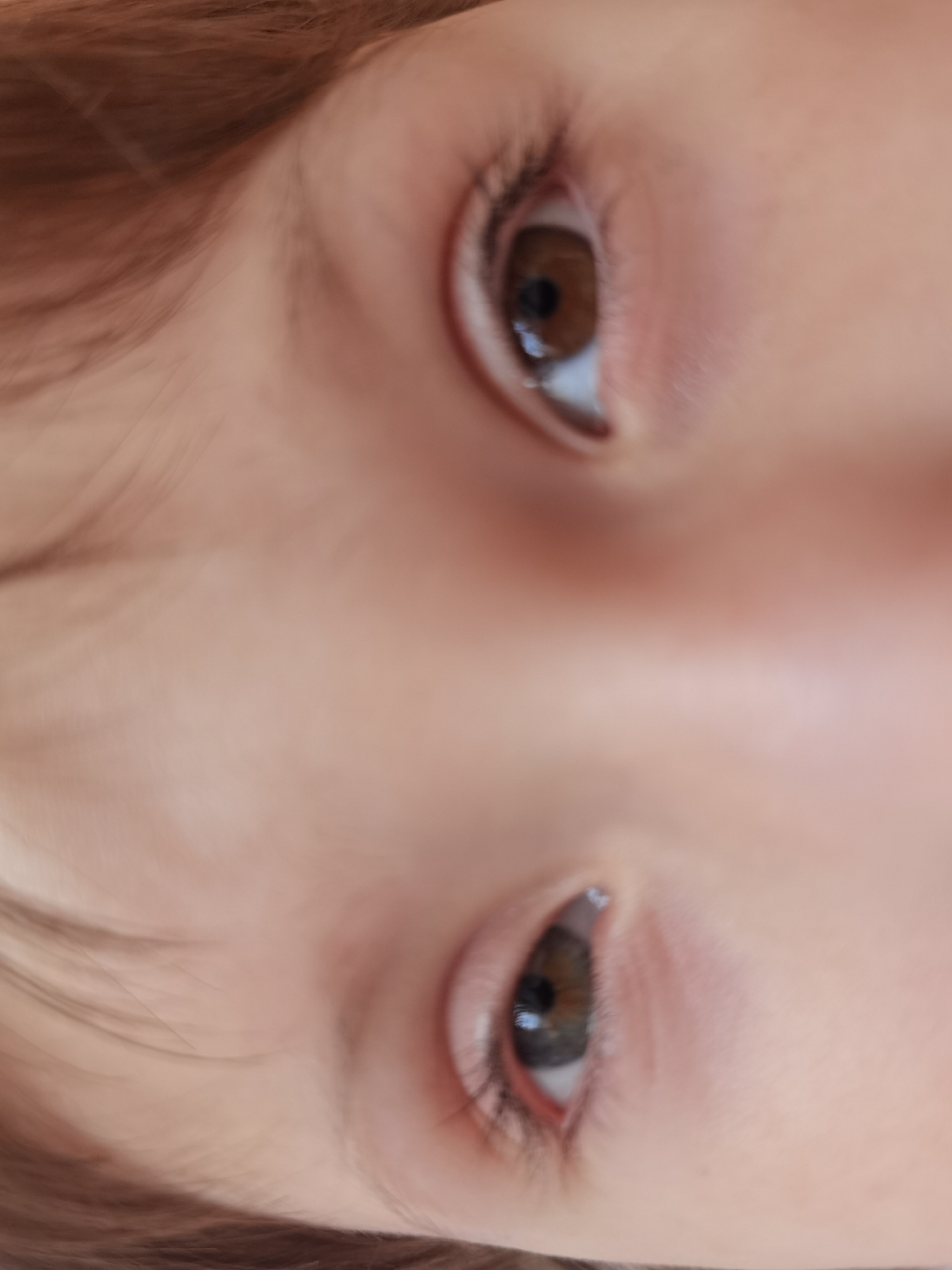 The image presents a close-up view of a person's face, specifically focusing on the eyes. The subject appears to have fair skin and eyelashes. The eyes themselves are brown. Due to the limited information, further details about the person, their actions, interactions, or the environment are not discernible from the image. The image does not provide any information to identify the location as Perm, Russia, or any other specific place.