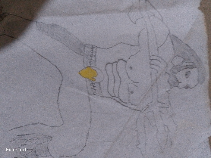 The image is a drawing of a figure, possibly a warrior or combatant, holding a weapon resembling a polearm or staff with multiple points. The figure wears what appears to be armor or protective gear around their midsection, with a yellow spade-shaped design at the center of a belt. The figure's face is visible, and they are depicted with some level of detail, including facial features. The background is plain and suggests the drawing was done on a piece of paper. No specific location in a city can be identified, as the drawing is not location-specific.
