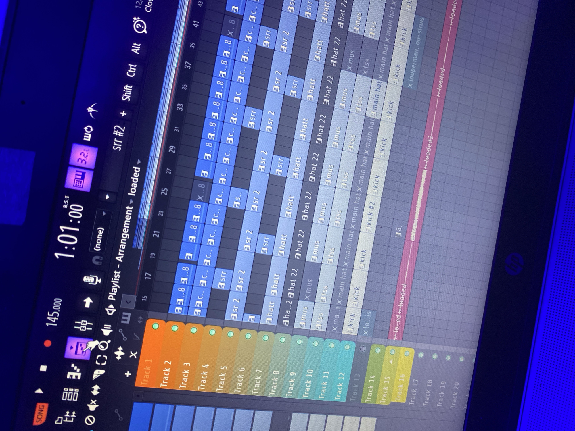 The image displays a computer screen showing the digital audio workstation FL Studio. The arrangement window is open, with multiple tracks containing various audio samples and loops arranged in a timeline. Visible tracks include drums (kicks, hi-hats), percussive elements (snares), and melodic elements. Track names include terms such as "kick," "hatt," "tss," "mus," and "sr2," indicating the types of sounds within those tracks. The playlist is set to "arrangement loaded" and the BPM is 145. The time signature appears to be 1:01:00. No people or location information (including Ibadan, Nigeria) is present in the image. The focus is exclusively on the software interface.