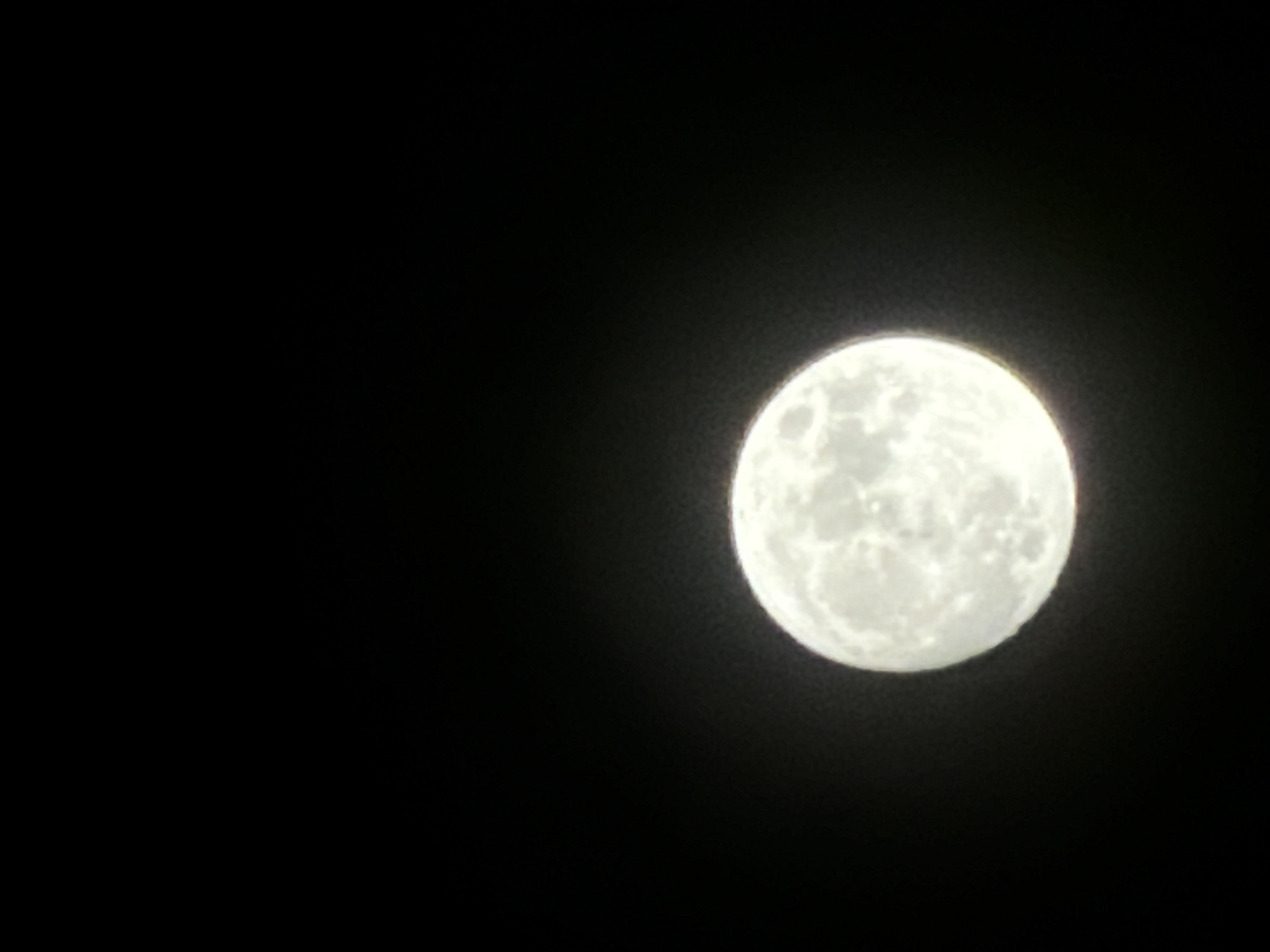 A bright, full moon dominates the right side of the frame against a stark black sky. No other objects or people are visible. Location: unknown (no information to indicate Burgas, Bulgaria).