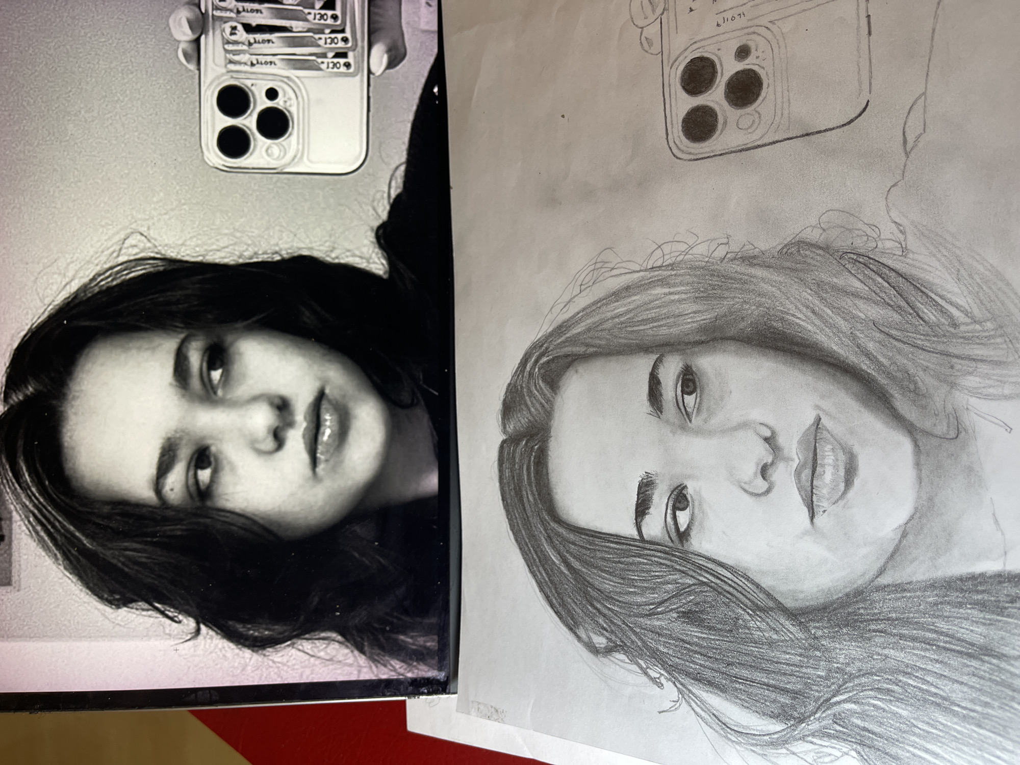The image presents a black-and-white photograph of a woman holding a phone taking a selfie, juxtaposed with a pencil sketch of the same scene. The woman has dark hair and light skin, and is looking into the camera. She is holding a smartphone with a multi-lens camera visible. The sketch appears to be an attempt to replicate the photograph. The background is indistinct. There is no evidence to indicate this image was taken in Jos, Nigeria.