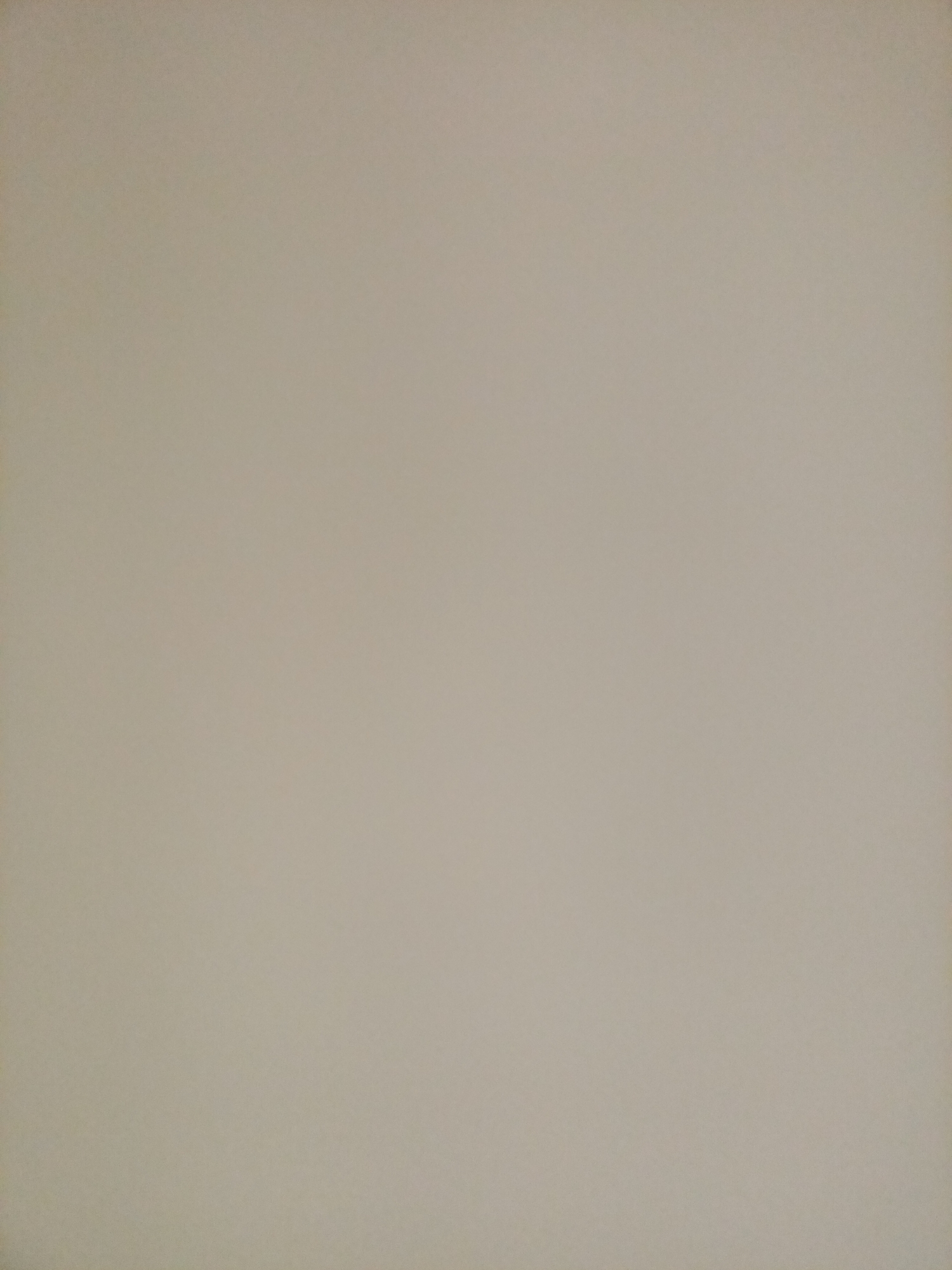 The image shows a plain, neutral-colored background, likely a wall or a sheet of paper. There are no discernible objects, people, or environmental features visible. The color is a light, desaturated beige or off-white. The lighting appears even, with no strong shadows or highlights. The image is consistent with a studio backdrop or a blank surface used for artistic or photographic purposes. There is no indication of the location being Rostov-on-Don, Russia.