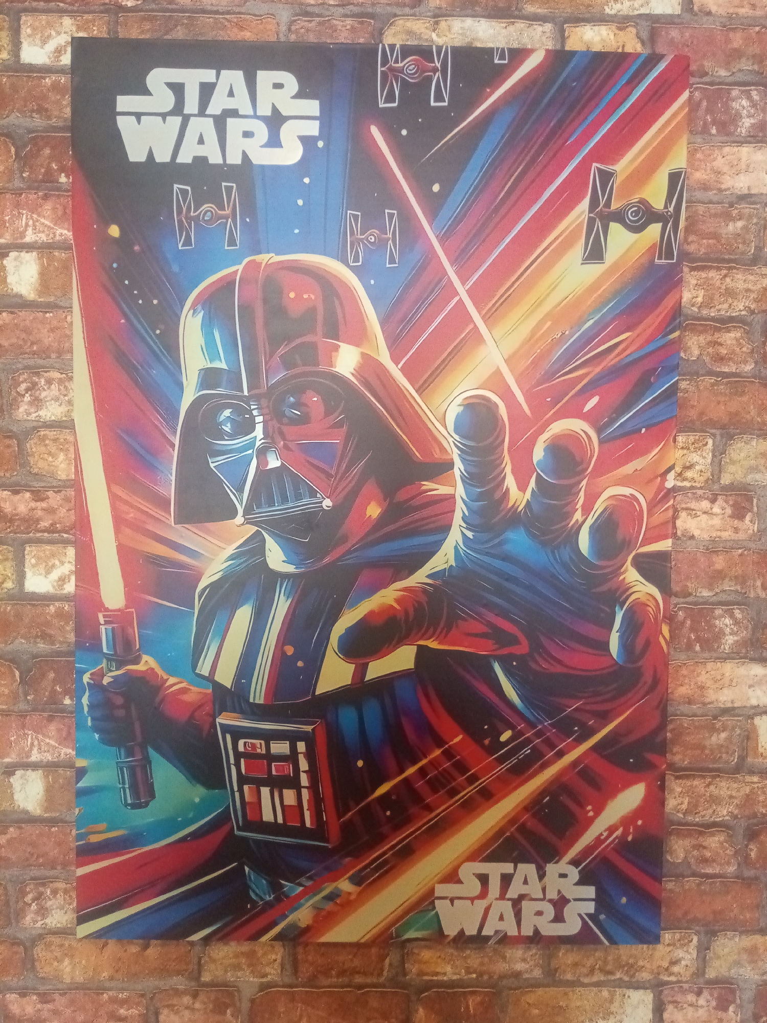 The image is a close-up shot of a Star Wars poster hanging on a brick wall. The poster features Darth Vader wielding a red lightsaber, with TIE fighters in the background and the Star Wars logo at the top and bottom. The overall color scheme of the poster is red, blue, and yellow. The brick wall has a worn appearance with variations in color. There is no indication of the location being Porlamar, Venezuela.