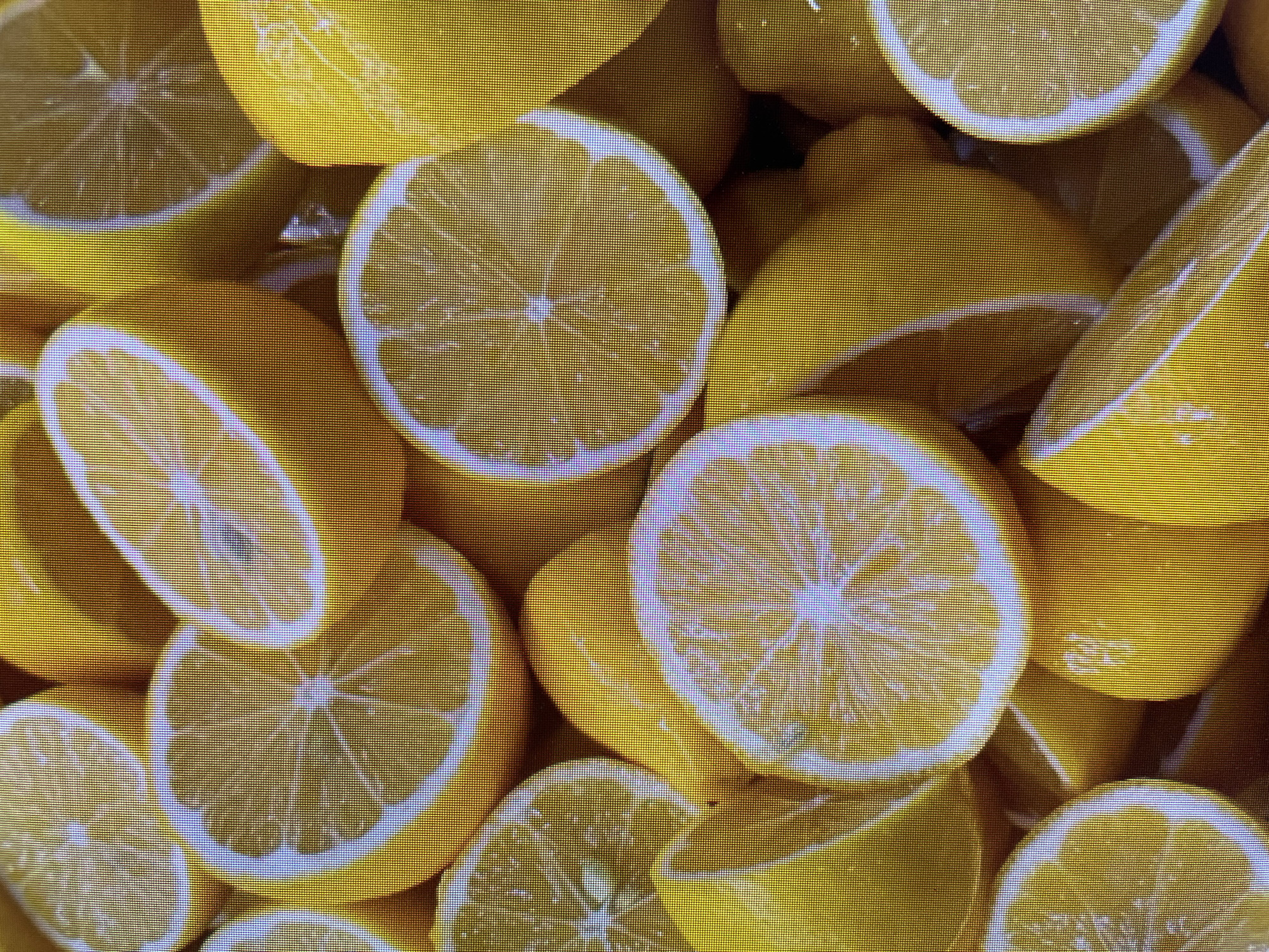 The image shows a close-up of numerous cut lemons. The lemons are sliced, revealing their juicy flesh and seeds. The predominant colors are yellow and white. There is no indication of the location being Poltava, Ukraine or of any people, actions, or interactions.