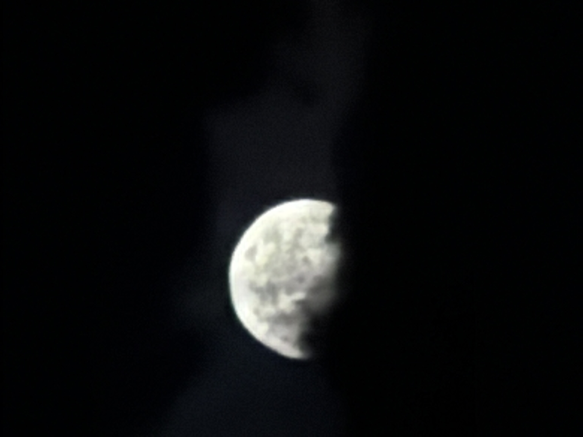 The image shows a crescent moon against a dark sky. It is unclear if the image was taken in Burgas, Bulgaria or any other location. No people, other subjects, objects, actions, or interactions are identifiable in the image. The environment consists of a dark sky partially obscuring the moon.