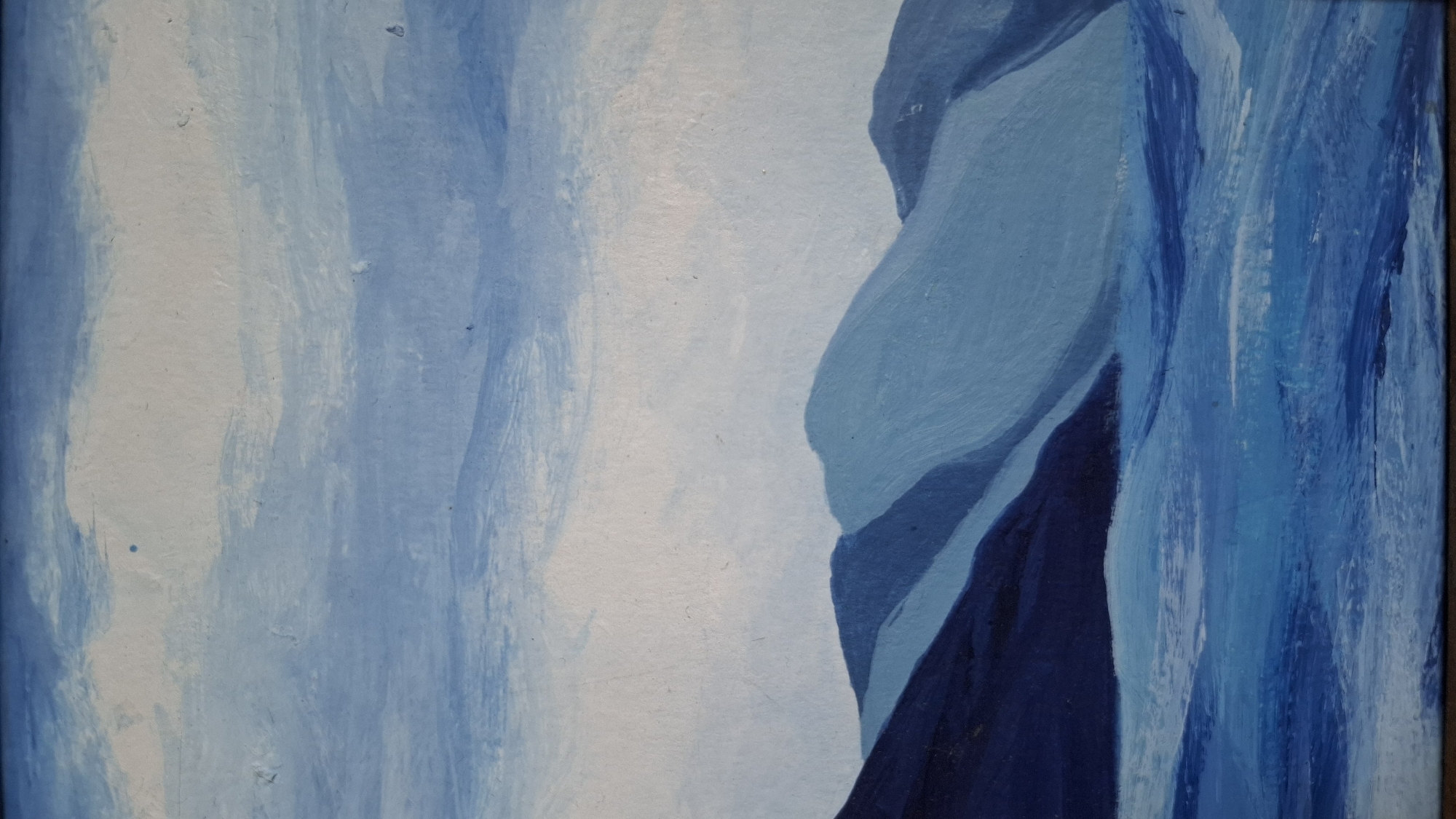 The image is a painting depicting a landscape, located in Novaya Vasil'evka, Russia. The scene is rendered predominantly in shades of blue, with varying tones creating depth and contrast. The upper section features a sky with broad, horizontal brushstrokes in light blue and white, suggesting clouds or atmospheric haze. Below this, a range of mountains or large hills occupies the mid-ground. These formations are layered, with the leftmost peak in the foreground appearing in a dark indigo blue, and subsequent peaks diminishing in color intensity to lighter blues as they recede towards the background. The lower section portrays a body of water, depicted with varying horizontal brushstrokes in brighter and darker blues, indicative of surface movement. No human figures or artificial structures are visible within the composition.