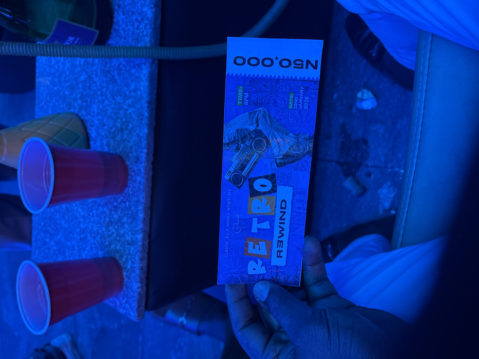 A blue-toned image features a hand holding a ticket for "RETRO REWIND" at Classic DJ x Royale Nightlife. The ticket indicates the event will be held on January 22nd, 2026, at 8 PM, and lists a price of N50,000. The ticket includes a graphic with a boombox and figures in the background. Red plastic cups and a pineapple-shaped object sit beside the ticket in the scene.