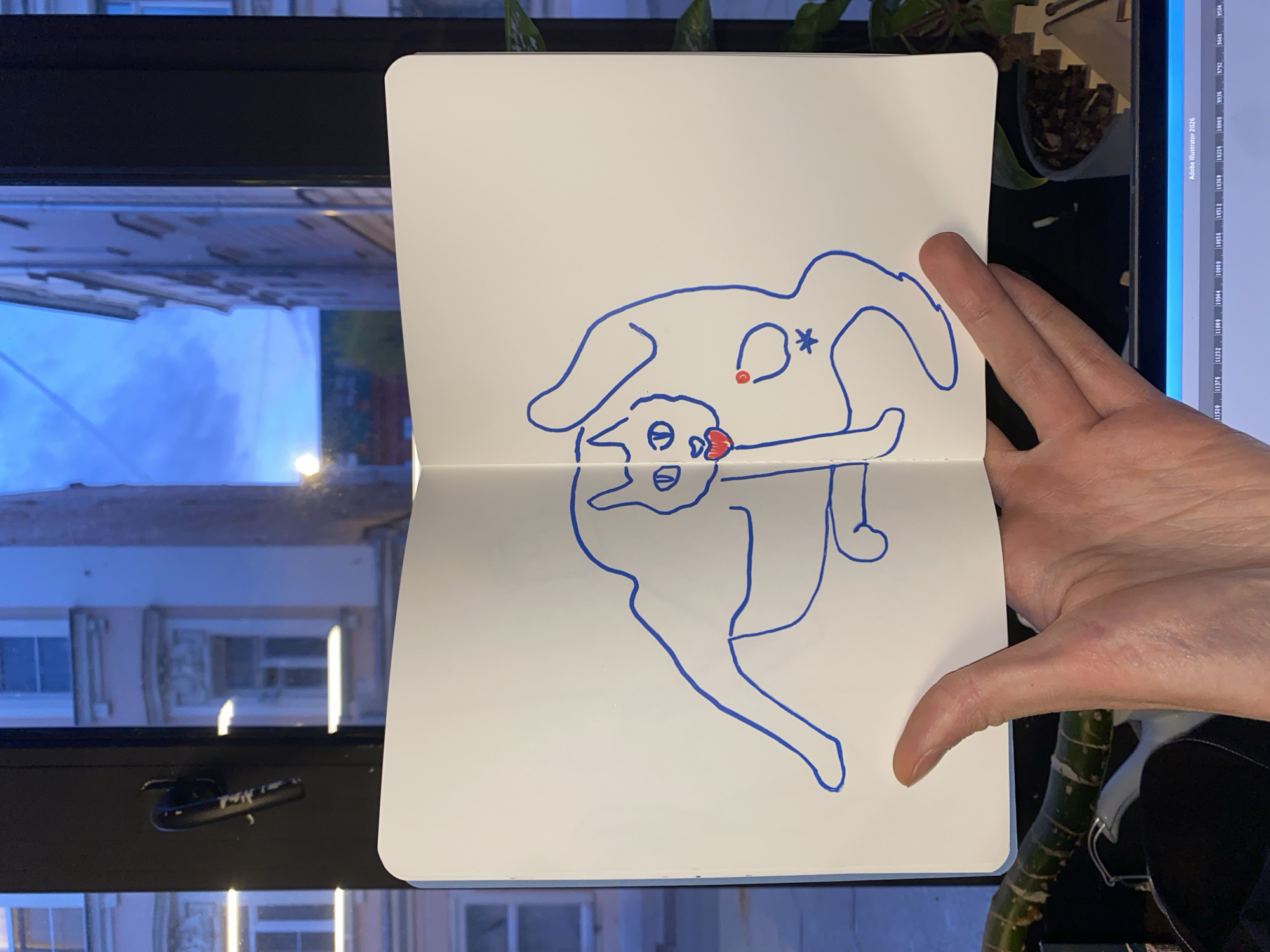 The image is a photograph of an open sketchbook with a blue line drawing of cartoonish figures on it. The sketchbook is being held in a hand, and in the background, a window offers a view of a building, possibly indicating an urban setting. The image also includes a glimpse of a computer screen displaying what appears to be an Adobe Illustrator interface. Additionally, there are plants visible in the background, placed either on the window sill or in front of it. The presence of the building visible through the window, along with the computer screen and plants, suggest an indoor environment with a view to the outside.
The text on the screen is an OCR text.
The location in the city of Moscow, Russia cannot be determined from this picture.
