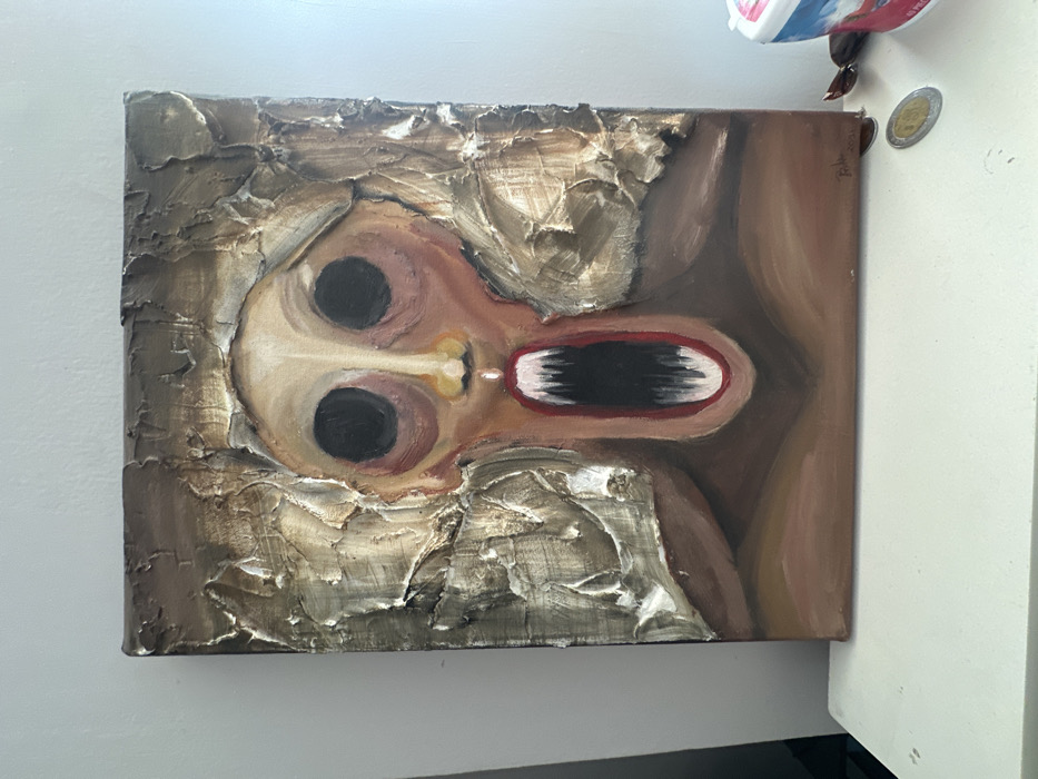 A grotesque, abstract face dominates a canvas with heavy impasto textures bordering the edges. Large, black, soulless eyes sit above a gaping, elongated mouth revealing dark, possibly decaying, teeth. A pale, fleshy tone comprises the skin, set against a background of smooth, brownish hues suggesting surrounding space or form. The crude brushstrokes and distorted features create a disturbing and unsettling image.