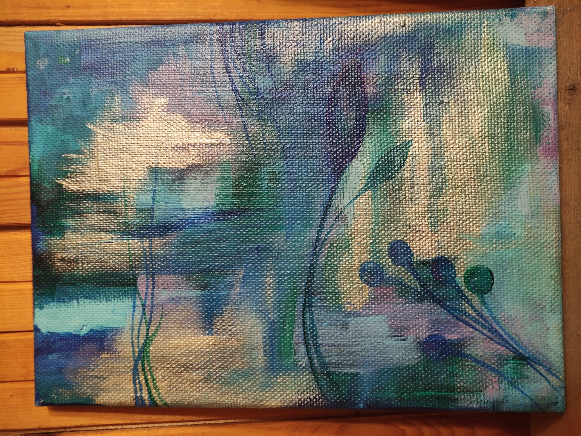The image shows an abstract painting on a canvas with a coarse texture. The dominant colors are blues, greens, and whites, creating a watery or forest-like atmosphere. There are suggestions of vertical lines and plant-like forms with dark, round shapes at the ends, positioned towards the lower right corner. The overall impression is that of an impressionistic or abstract depiction of nature. The location in the city of Unknown, Unknown is not relevant as the subject is a painting, not a real-world location.