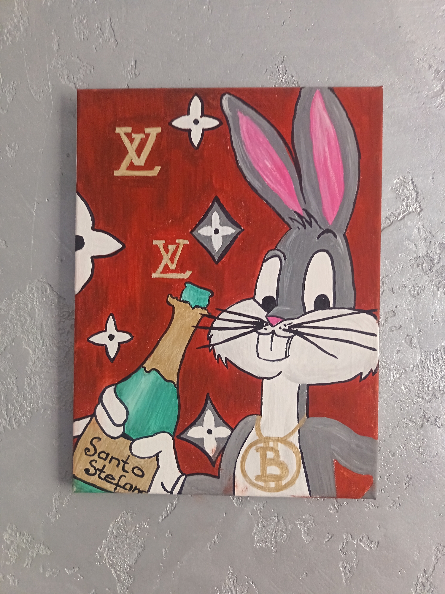 A hand-painted acrylic artwork on canvas depicts Bugs Bunny holding a bottle of "Santo Stefano" sparkling wine. The background is a vibrant red with repeating Louis Vuitton-inspired motifs of the LV monogram and four-petal flowers. Bugs Bunny is rendered in his classic grey, white, and pink color scheme, with a gold chain around his neck featuring a Bitcoin logo. The canvas is displayed on a textured grey wall. The artwork is vertical and appears to be a decorative piece.