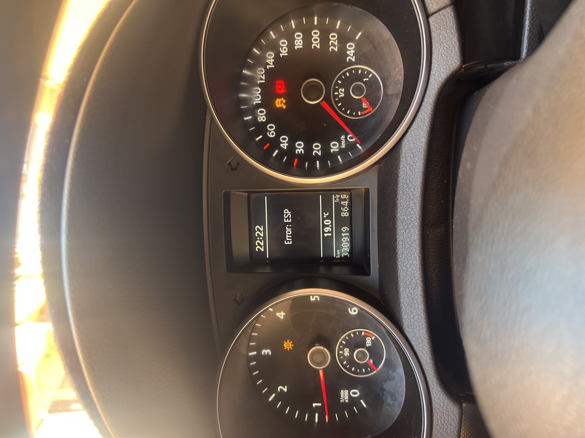 The image shows the dashboard of a car. The dashboard displays an error message "Error: ESP," a time of 22:22, a temperature of 19.0°C, and a mileage of 33019 km. The speedometer reads close to 0 km/h and the tachometer reads about 900 RPM. Warning lights are illuminated, including a tire pressure warning, and an ESP light. The image provides no information to determine the location of the car in Ouaouizert, Morocco or the date.
