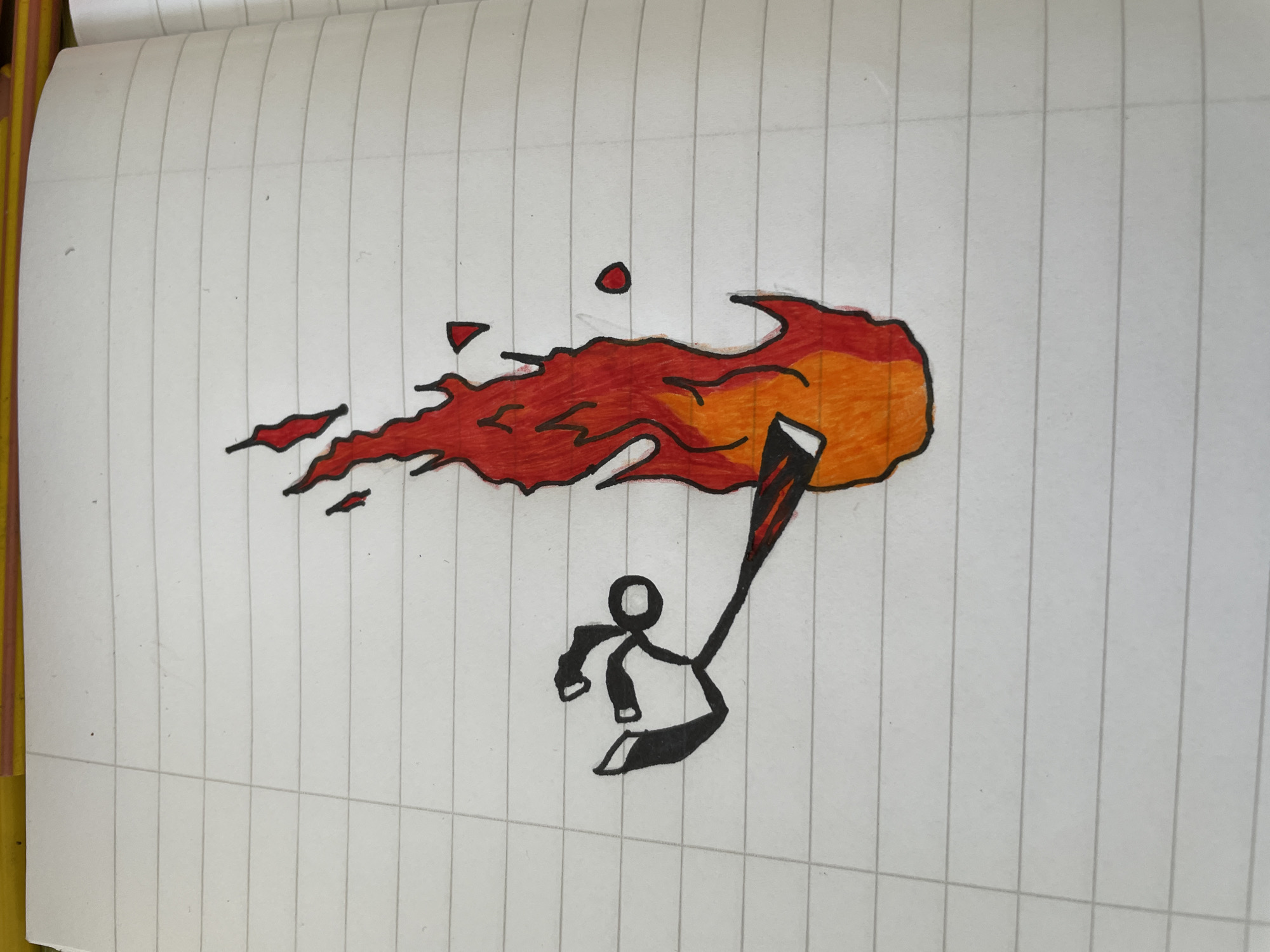 A drawing on lined paper depicts a stick figure holding a torch that is engulfed in flames. The flames are colored in shades of red and orange. The stick figure is black. The background is white lined paper. There are no indications that the image is set in Zlatograd, Bulgaria.
