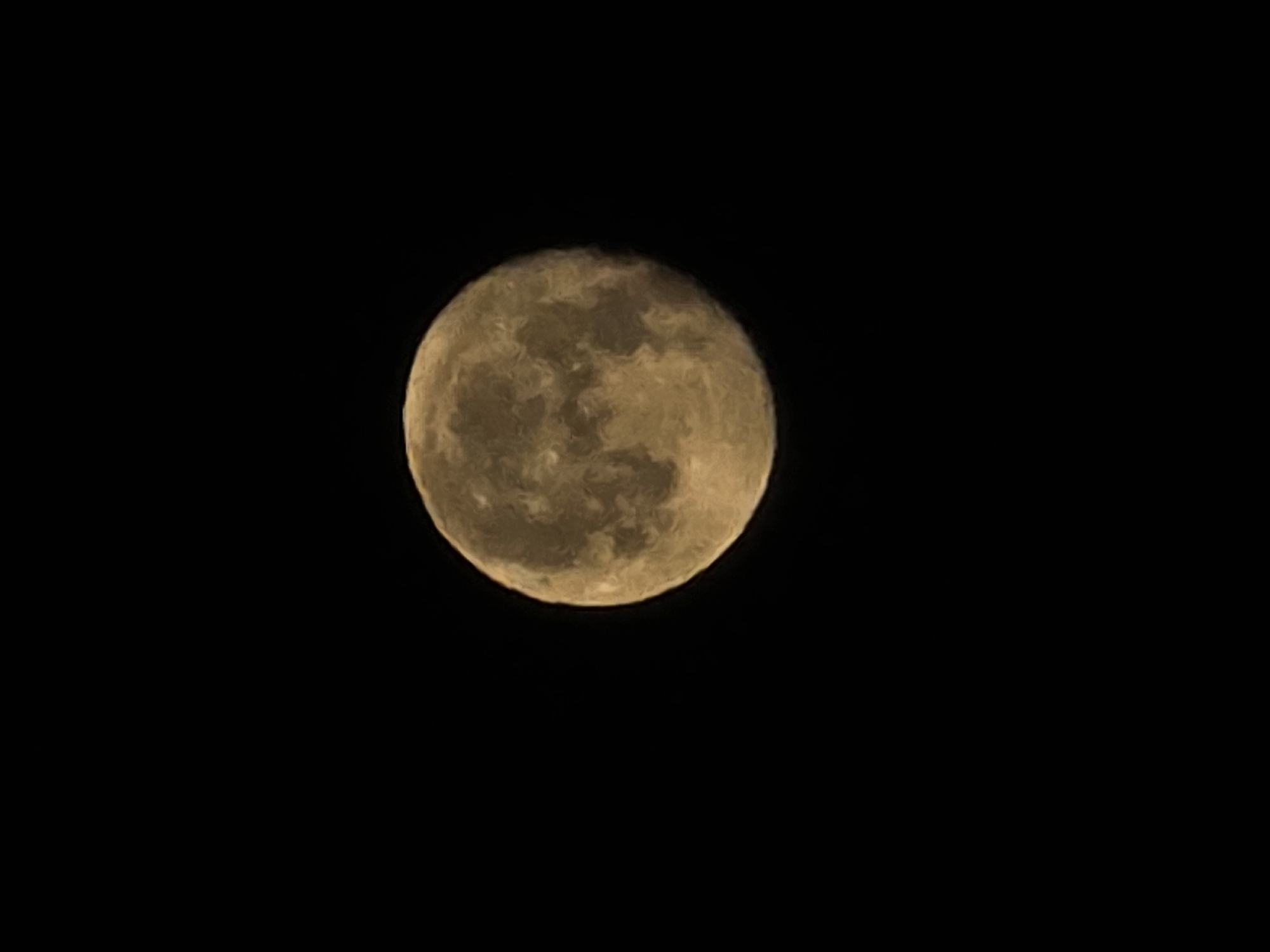 A full moon is pictured against a black, starless sky. The moon is a warm, golden-yellow color with visible craters and maria. The image is centrally framed with the moon occupying the right two-thirds of the frame, leaving the left third entirely black. There are no discernible landmarks or environmental details visible that would indicate a specific location in Worms, Germany.