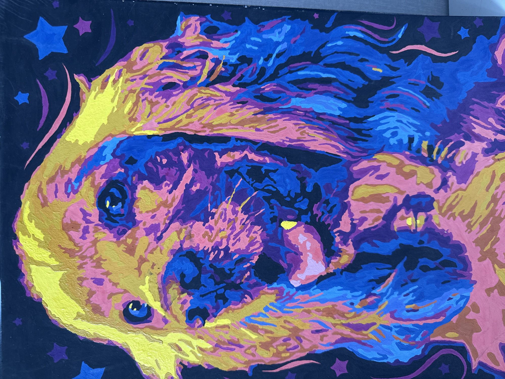 The image is a close-up, full-frame, vertical painting of a dog's head against a dark background. The painting uses a vibrant, pop-art style with bold, contrasting colors like yellow, pink, blue, and purple applied in blocky, distinct strokes. The dog appears to be a Golden Cocker Spaniel, with its long, floppy ears and expressive eyes. Its mouth is open, with its tongue lolling out, giving it a joyful or panting appearance. The background is a deep, solid black, punctuated by scattered stylized stars in blue and purple, and thin, curved lines in pink and purple that suggest movement or whimsical decoration. The overall impression is one of energetic and playful depiction of the animal.
