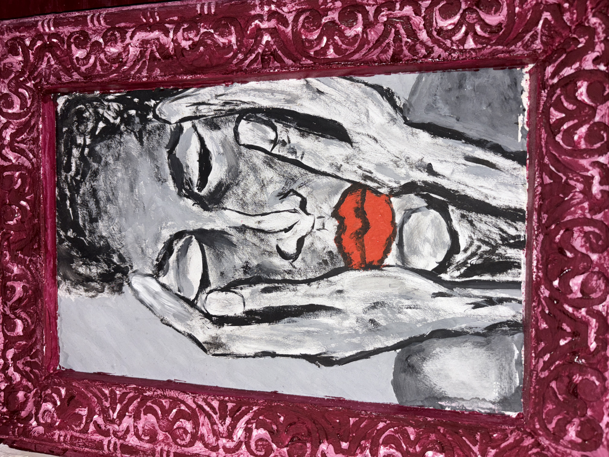A framed painting depicts a close-up portrait of a person with their hands covering their eyes. The painting is rendered in a monochromatic style with shades of gray and black, with the exception of bright red lips. The person's hair is dark and textured, and their eyes are closed. The background of the painting is a light gray. The frame is ornate and appears to be made of wood, painted a deep magenta color with raised patterns. The overall impression is one of intense emotion or introspection. The context of Alaverdi, Armenia, is not discernible from the image itself.