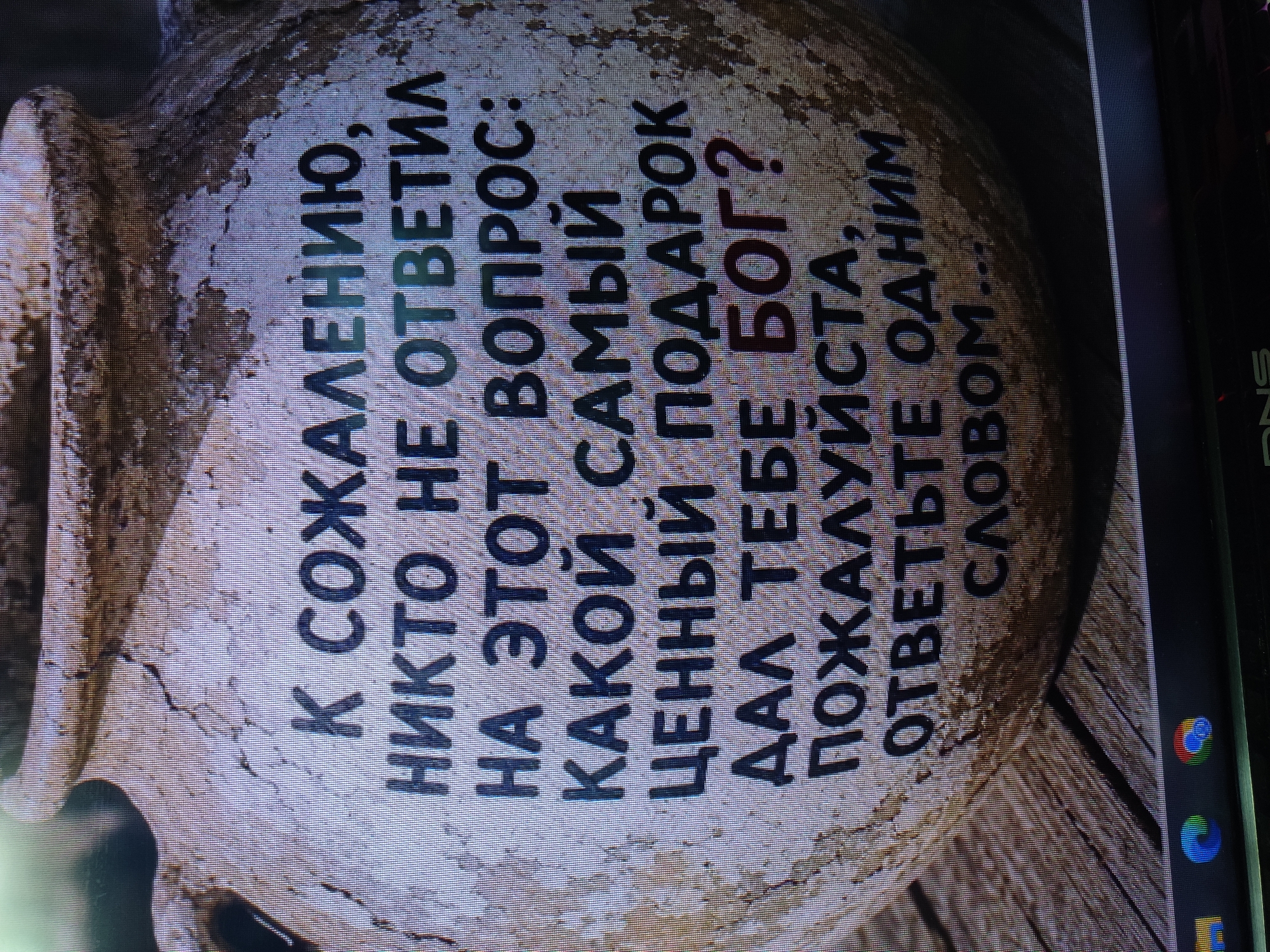 The image displays text on a rough, textured surface that resembles an ancient clay pot or vessel. The text is in Russian and reads: "К СОЖАЛЕНИЮ, НИКТО НЕ ОТВЕТИЛ НА ЭТОТ ВОПРОС: КАКОЙ САМЫЙ ЦЕННЫЙ ПОДАРОК ДАЛ ТЕБЕ БОГ? ПОЖАЛУЙСТА, ОТВЕТЬТЕ ОДНИМ СЛОВОМ..." which translates to "REGRETTABLY, NO ONE HAS ANSWERED THIS QUESTION: WHAT IS THE MOST VALUABLE GIFT GOD HAS GIVEN YOU? PLEASE ANSWER IN ONE WORD...". There is no identifiable information or context suggesting a location in Noginsk, Russia, nor are there any people, actions, or interactions depicted. The scene is static and focuses solely on the inscription.