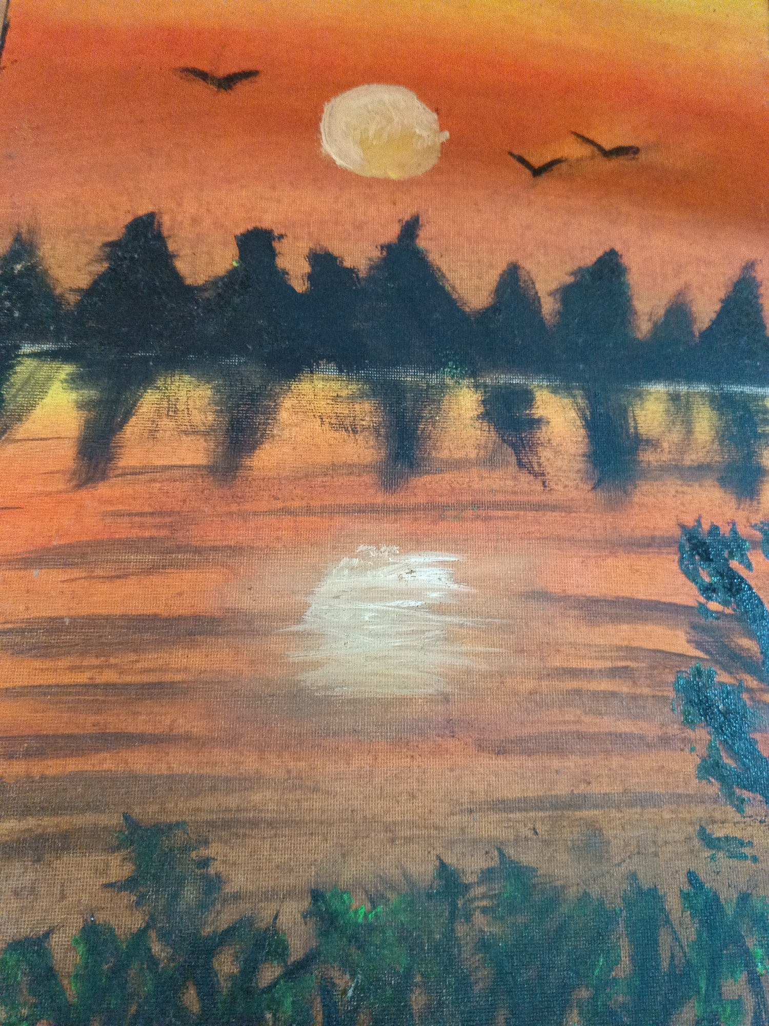 The image is a painting of a sunset landscape. The sky is a gradient of orange hues, with a pale yellow moon at the top center and silhouettes of three birds flying above the tree line. Below the sky is a dark silhouette of a forest reflected in a body of water. At the bottom of the painting is a dark line of trees with dark green tops. A bright yellow color reflecting the sunset's light, is painted onto the surface of the water. The painting is likely inspired by Tinaquillo's geographical environment, but is not conclusive. The details of the environment are not detailed enough to make a determination of location within the city of Tinaquillo, Venezuela.