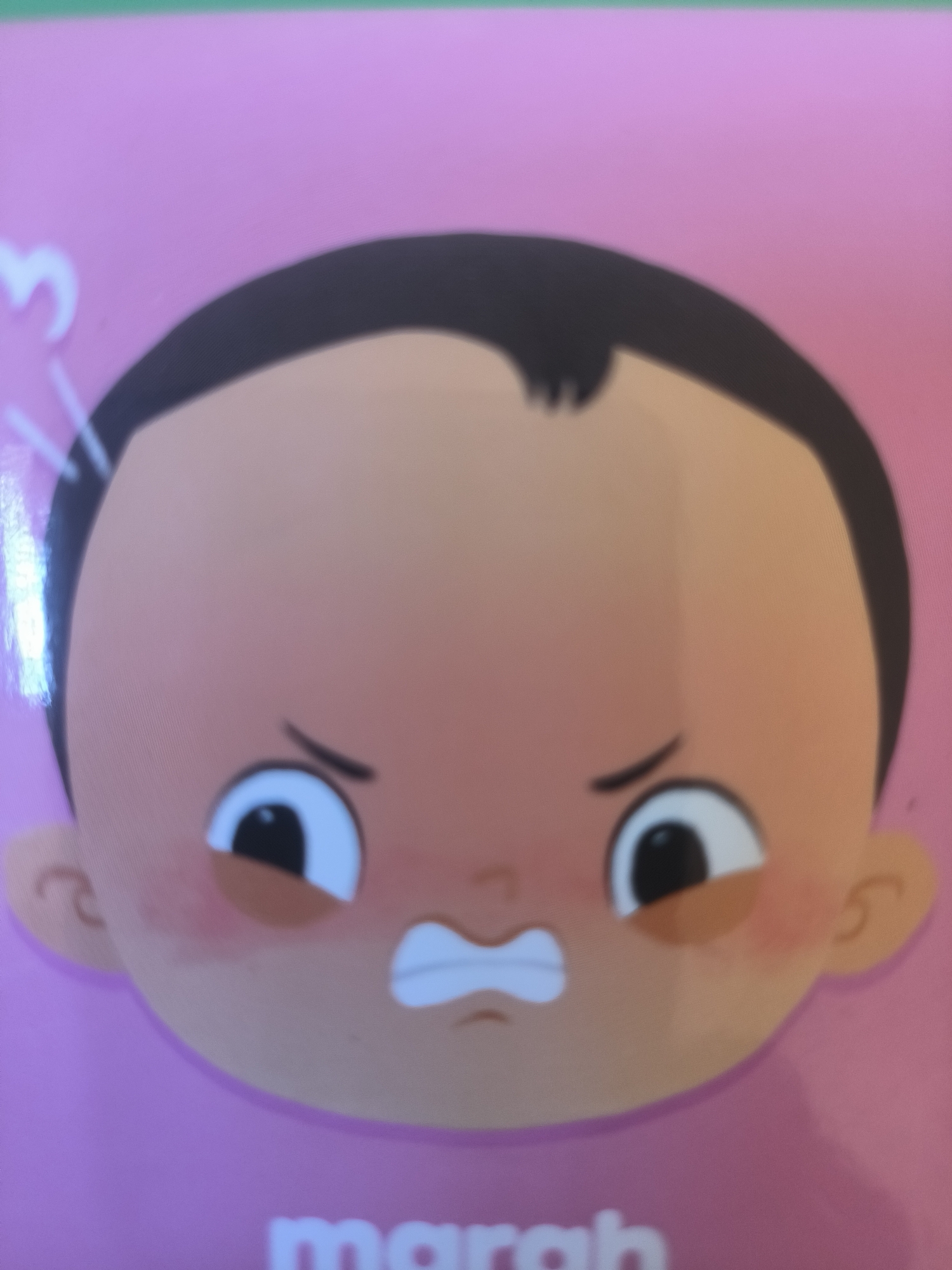 A cartoon-style illustration of a child's face expressing anger. The child has brown hair, brown skin, and is set against a pink background. A portion of the word "marah" (meaning "angry" in Malay/Indonesian) is visible below the face. There is no indication of the location being Lhokseumawe, Indonesia.