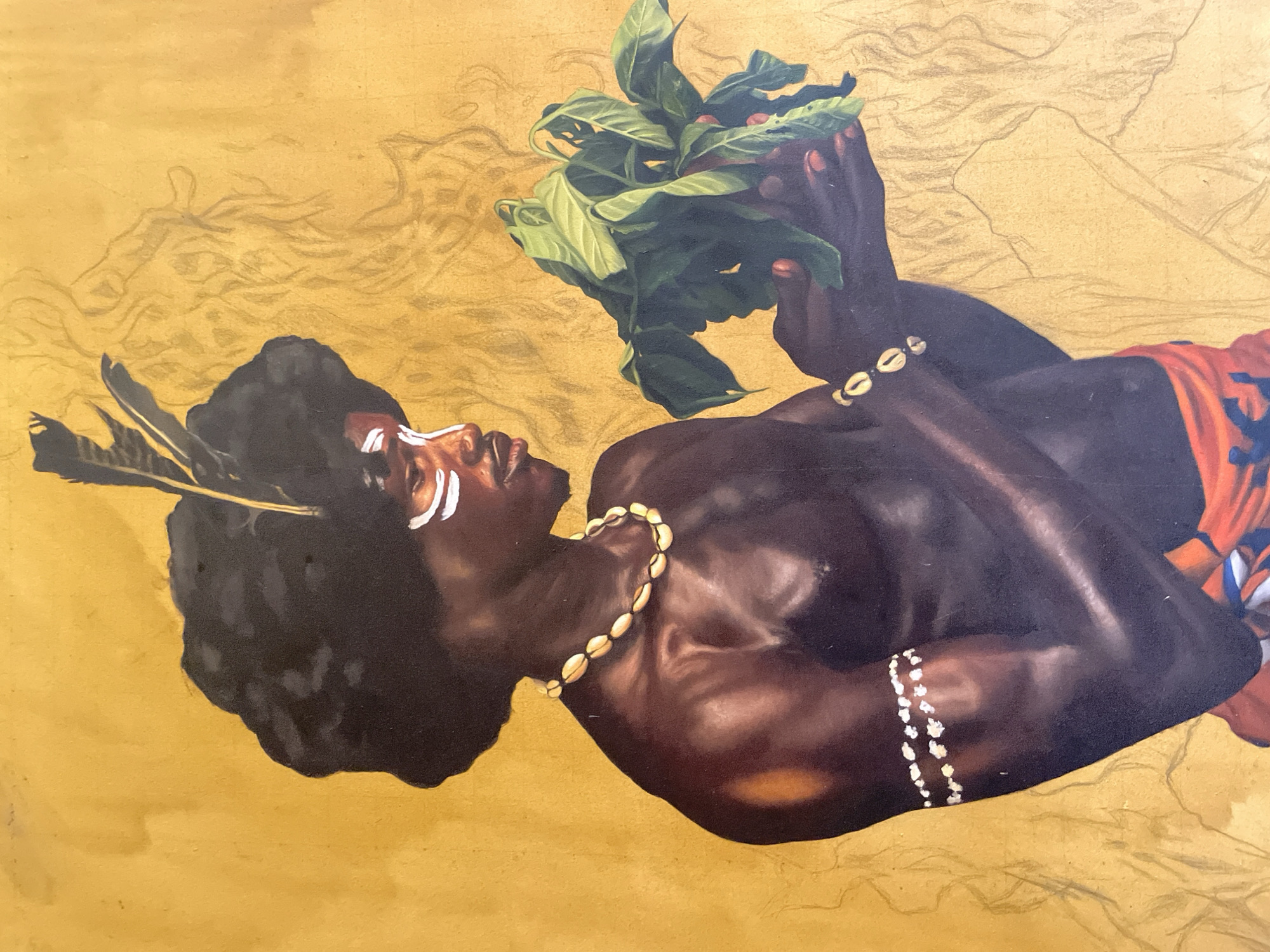 A painted portrait of a dark-skinned man lying on his side against a gold background. He has a thick afro adorned with feathers, and white markings on his face. He wears shell necklaces and a wristband. He holds a bunch of green leaves and red berries in his hands. The background appears to be unfinished, with faint sketches of figures or landscape elements visible. The location is not depicted in the image. The painting does not depict actions or interactions beyond the man holding the leaves. There is nothing in the scene that clearly marks it as Ado, Nigeria.