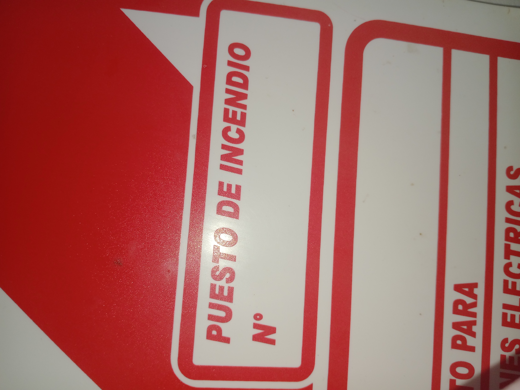 The image shows a portion of a fire safety sign in Spanish. The visible text reads "PUESTO DE INCENDIO" and "N°". Another sign is partially visible, reading "TO PARA NES ELECTRICAS". The sign has a red background with white text. The image does not provide any information about the location in Buenos Aires, Argentina, or any details about people, actions, or interactions.