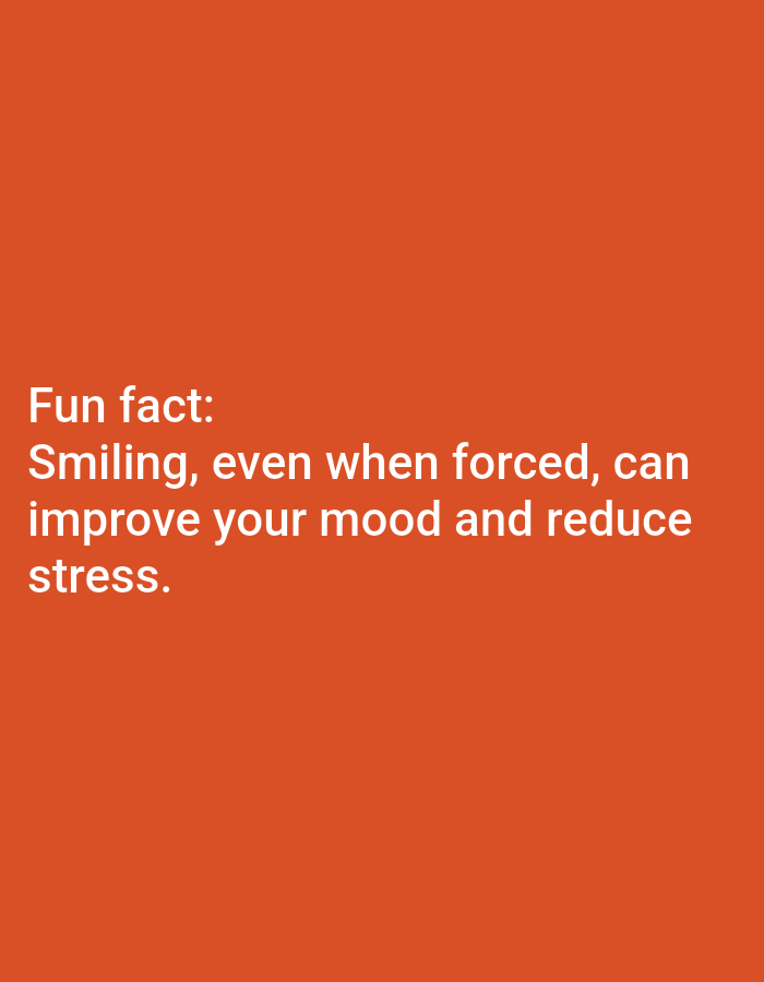 The image displays white text on a solid orange background. The text reads: "Fun fact: Smiling, even when forced, can improve your mood and reduce stress." There are no people, objects, or environmental details present in the image, and therefore no information can be provided about its location in Lagos, Nigeria.