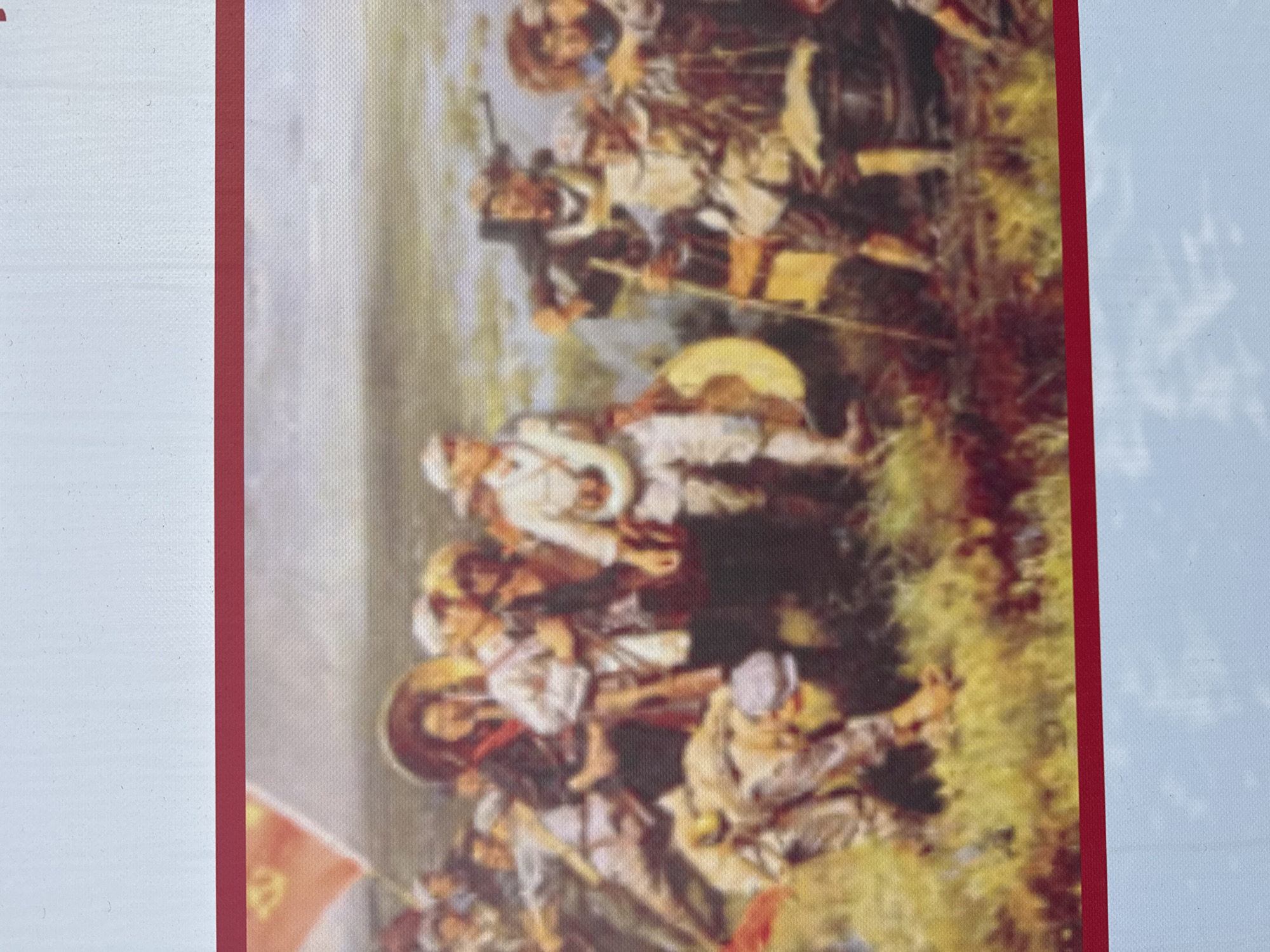 The image is of a painting depicting a historical battle scene. The scene features soldiers in white uniforms and head coverings engaged in combat. Some soldiers carry rifles, while others wield swords and shields. A flag with a symbol is visible in the lower left corner. The battle takes place in a field setting, with vegetation and uneven terrain. The painting is framed with a red border and appears to be on display, possibly a print or reproduction. There is no immediate indication of a specific connection to Zhongtun, China, from the image itself.