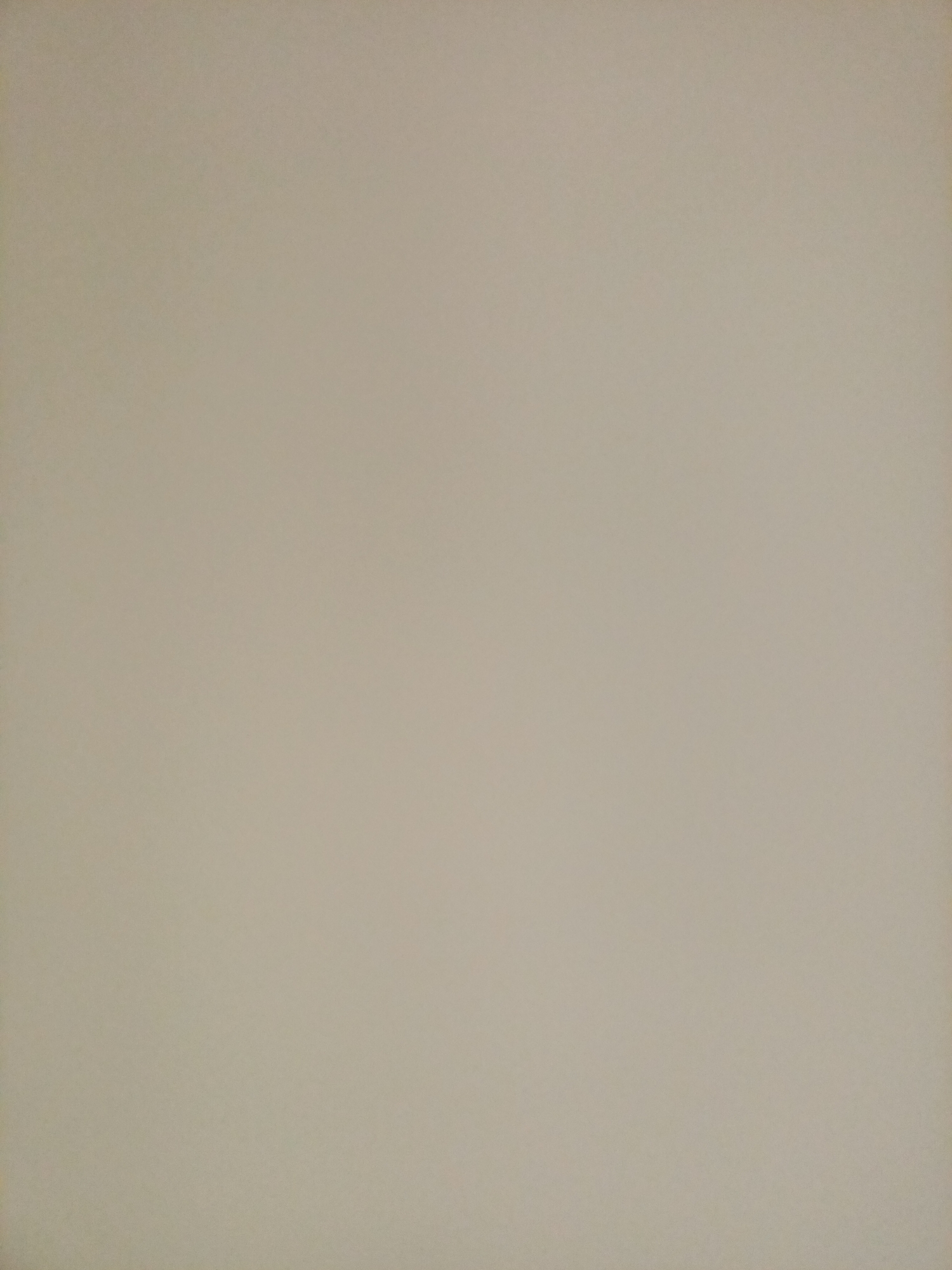 This image is a photograph of a plain, light beige wall. There are no objects, people, or distinguishing features visible in the image. The lighting is even, and there are no shadows. The image is a solid color, and it is impossible to determine the location or any other details from it.