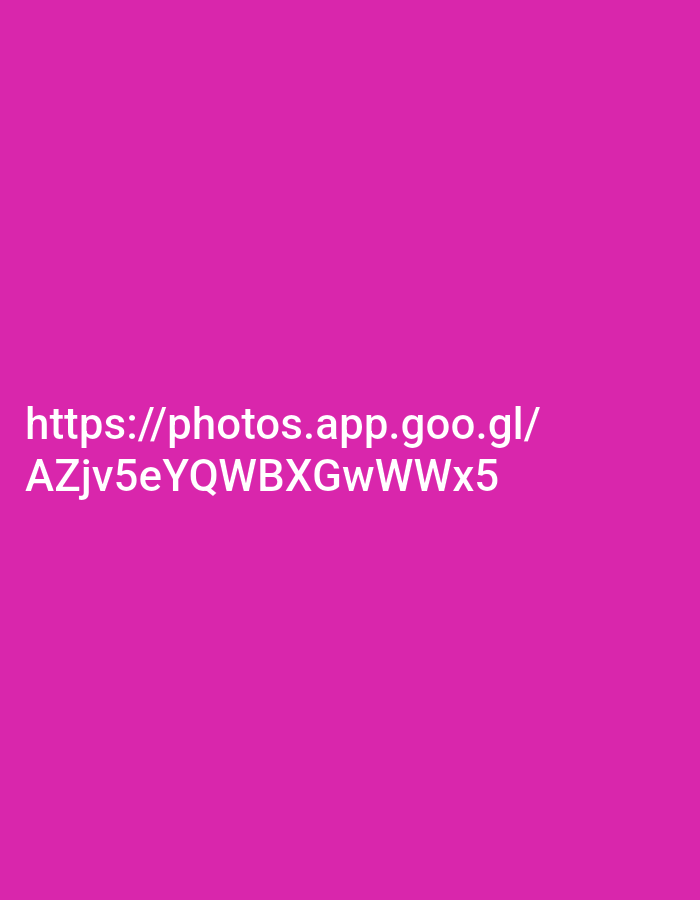The image shows a bright pink background with white text. The text reads "https://photos.app.goo.gl/ AZjv5eYQWBXGwWWx5". There are no people, objects, or any discernible environment depicted in the image, and therefore no information about the city of Kodaria, India, can be extracted from it.