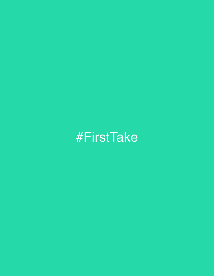 The image displays a solid teal digital graphic. Centrally positioned on this background is the white text "#FirstTake". No individuals, physical objects, actions, interactions, or discernible environmental features are depicted within the image itself. The scene is a digital graphic associated with the city of Yokneam Ilit, Israel.