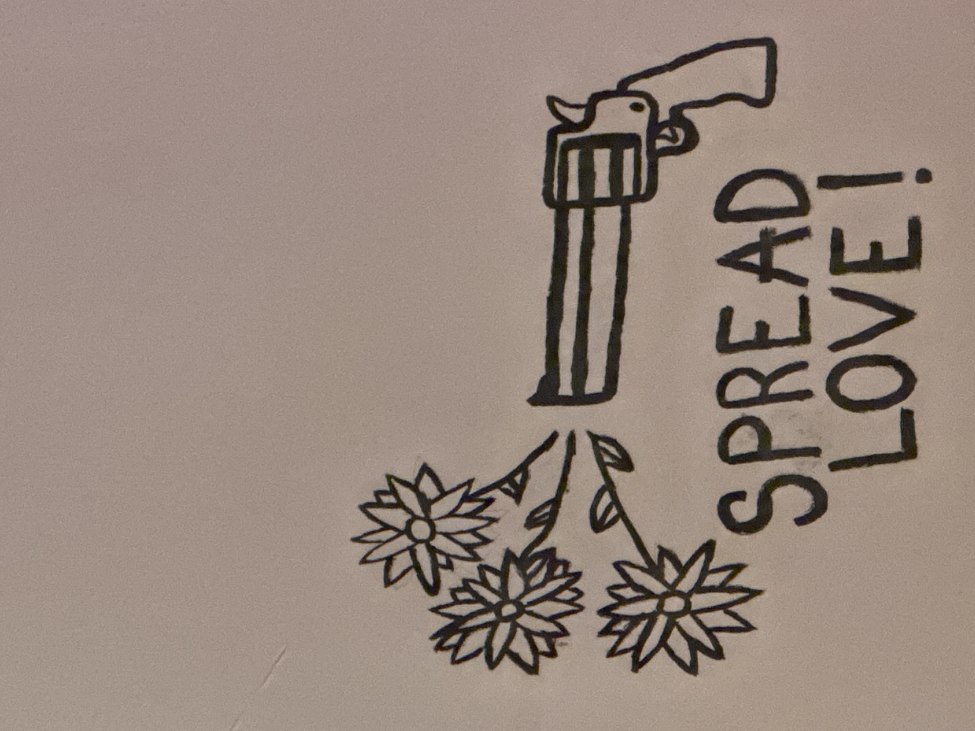 This image displays a drawing rendered in black outline on a light-colored, subtly textured surface, located in Castelnuovo di Porto, Italy. The drawing centrally features a stylized revolver-type handgun oriented horizontally, with its barrel pointing towards the left. Emanating from the muzzle of the handgun are three distinct, stylized flowers, each with multiple petals and a central circle, supported by stems with small leaf structures. Below and to the left of this composite image, the phrase "SPREAD LOVE!" is handwritten in bold, capitalized block letters. The background of the image is a uniform, plain light tone. No individuals are visible in the scene.
