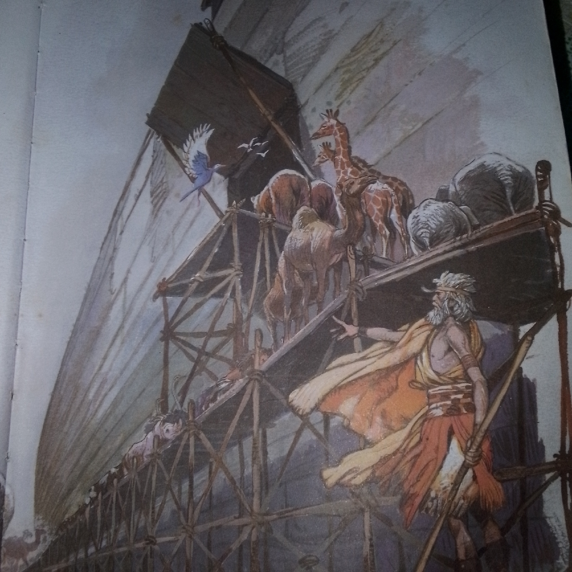 This is a painting depicting Noah's Ark. A man with a long white beard and hair, wearing a yellow cloak and an orange garment, stands on scaffolding on the right side of the frame. He holds a wooden pole. Various animals, including giraffes, bears, camels, and elephants, are visible on different levels of the ark, which is under construction. A blue bird with white wings is flying to the left of the ark. In the lower left, a child with dark hair looks over the edge of the scaffolding. The background is a pale, textured sky. There is no indication of the city of Jalingo, Nigeria, in this image.